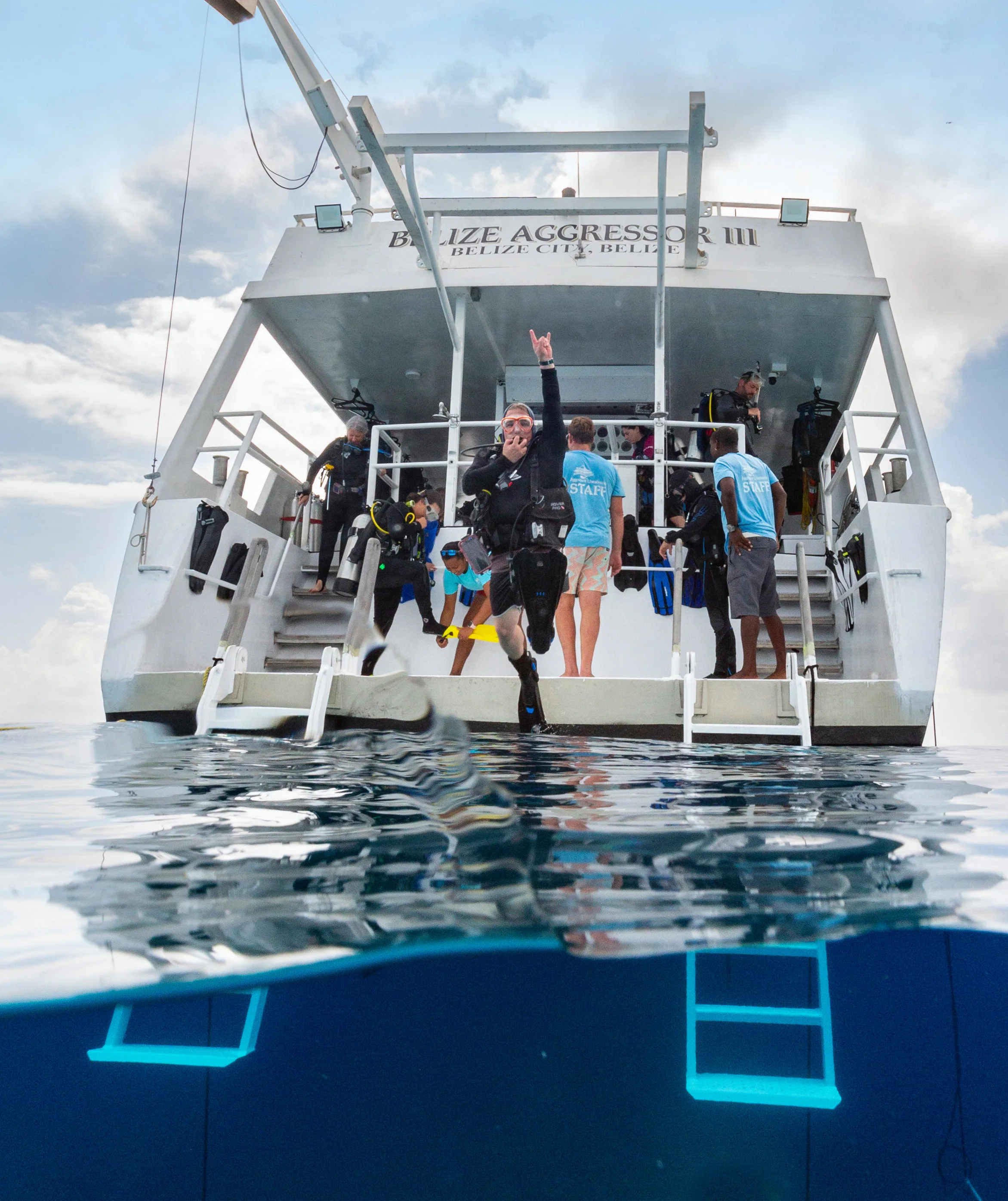 Divers on the stern of Belize Aggressor III about to giant-stride in