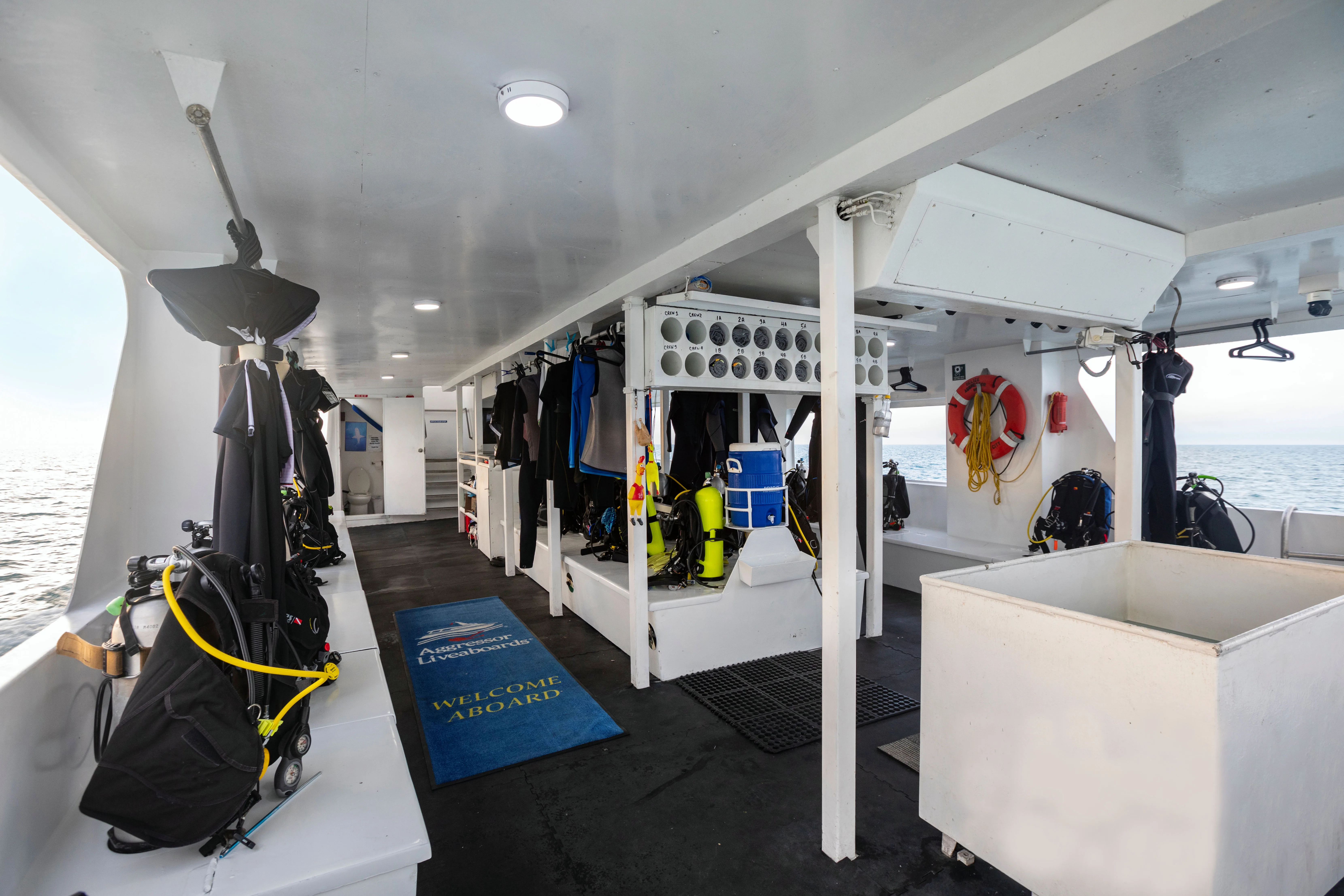 Dive deck of Belize Aggressor III with personal stations and gear