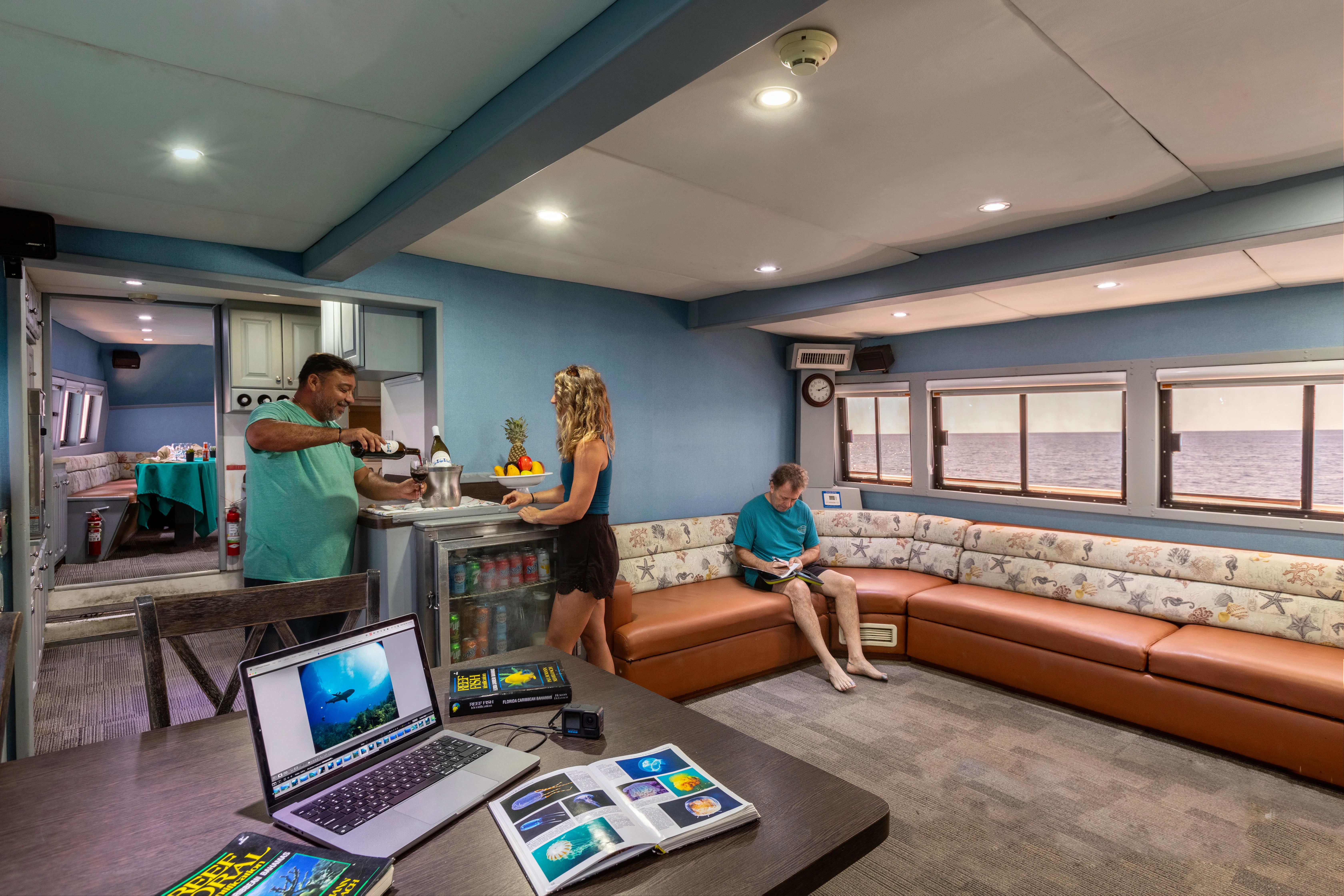 Saloon of Belize Aggressor III with corner sofa and work table