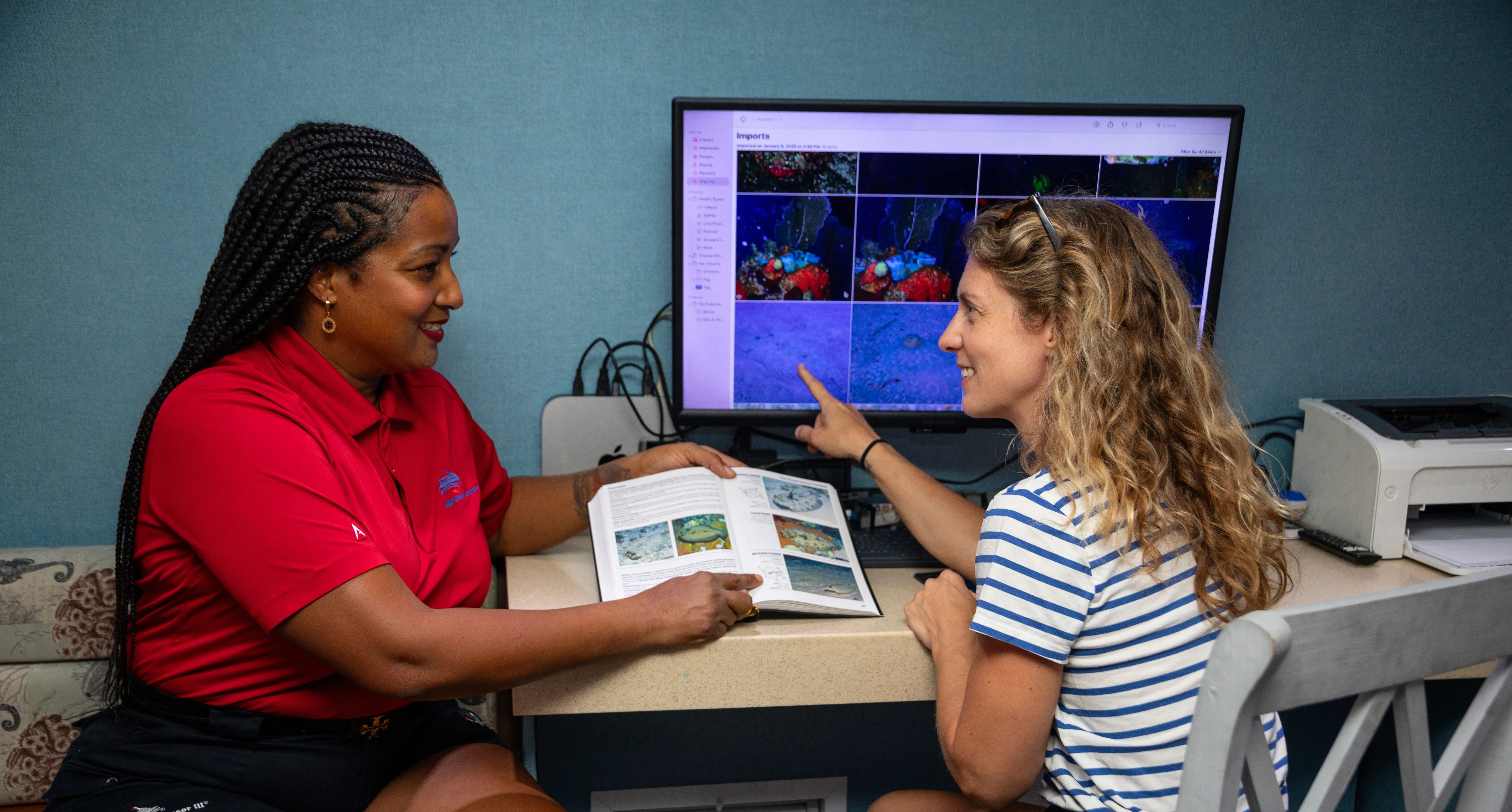 Photo centre of Belize Aggressor III — reviewing images after the dives