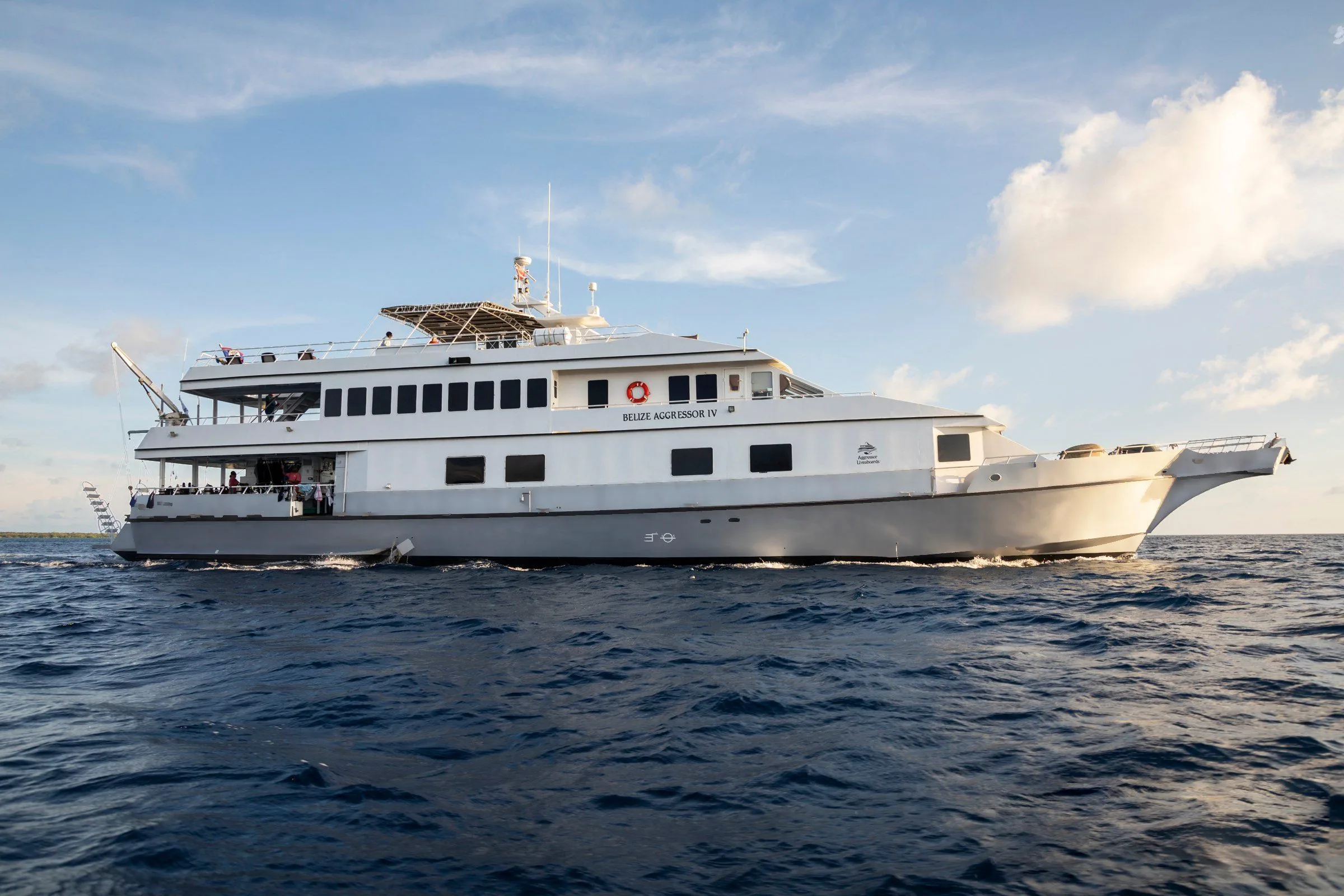 Belize Aggressor IV at sunset, her name across the superstructure