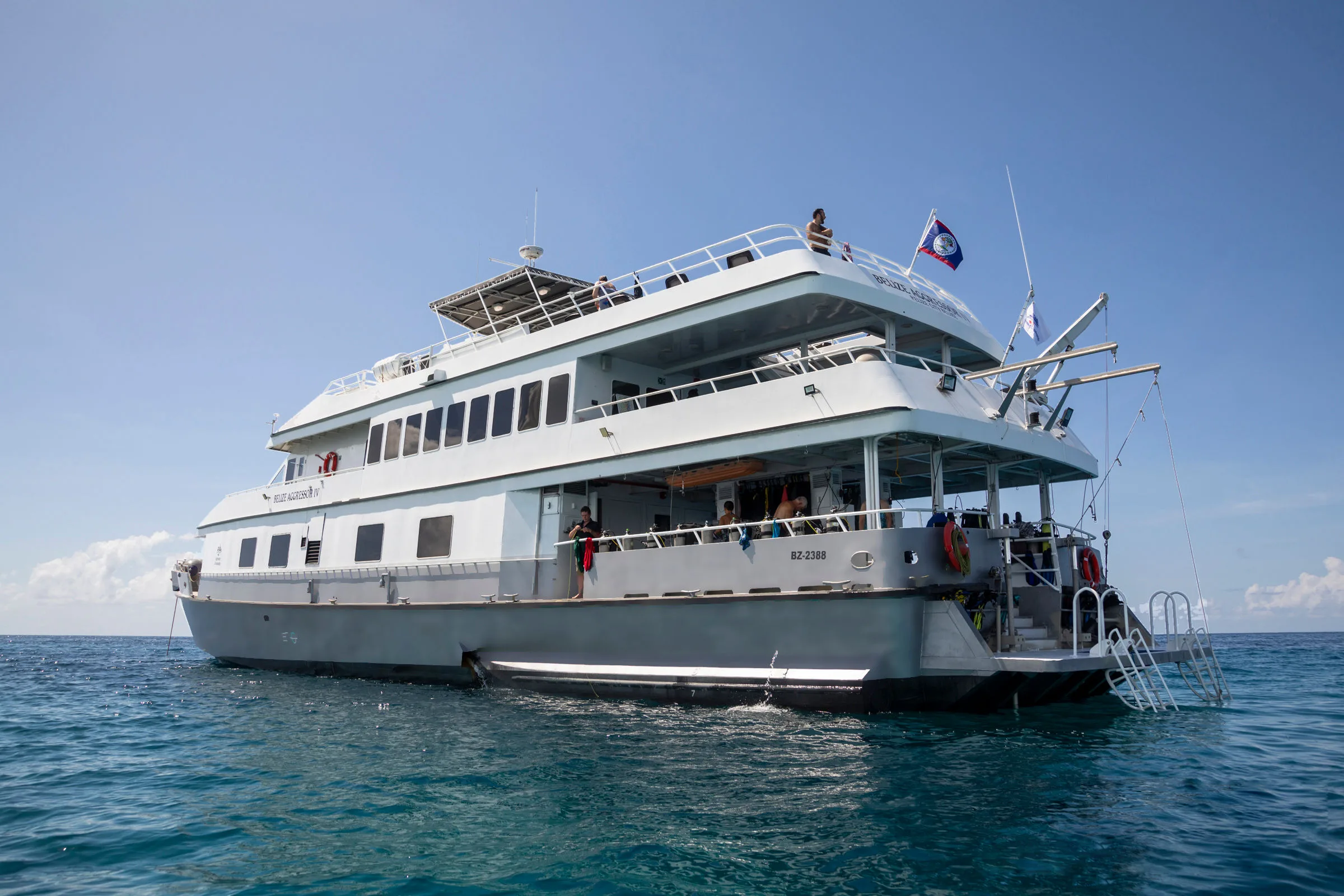 Stern of Belize Aggressor IV with the dive platform and boarding ladders