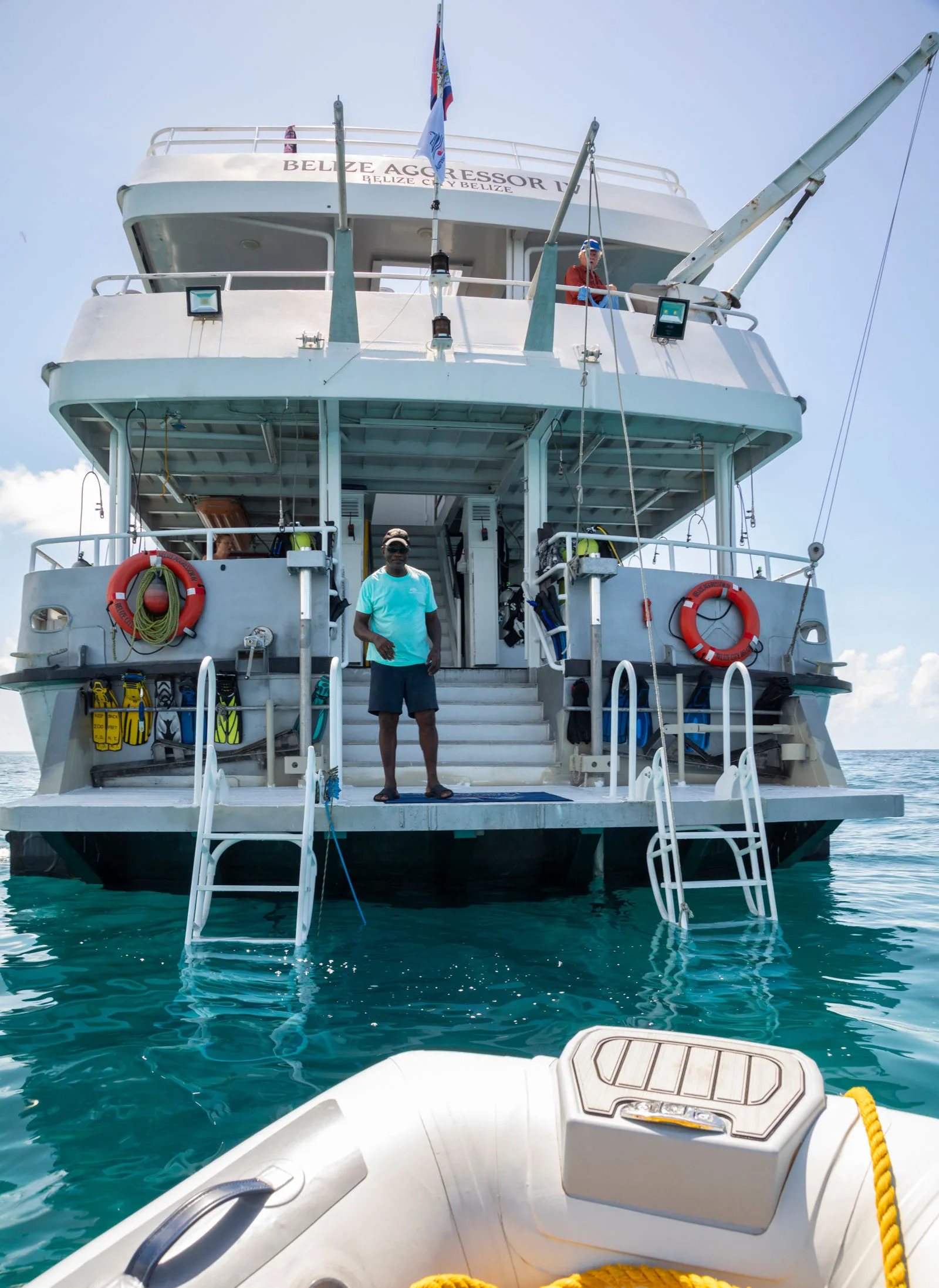 Crew member welcoming divers on the entry platform