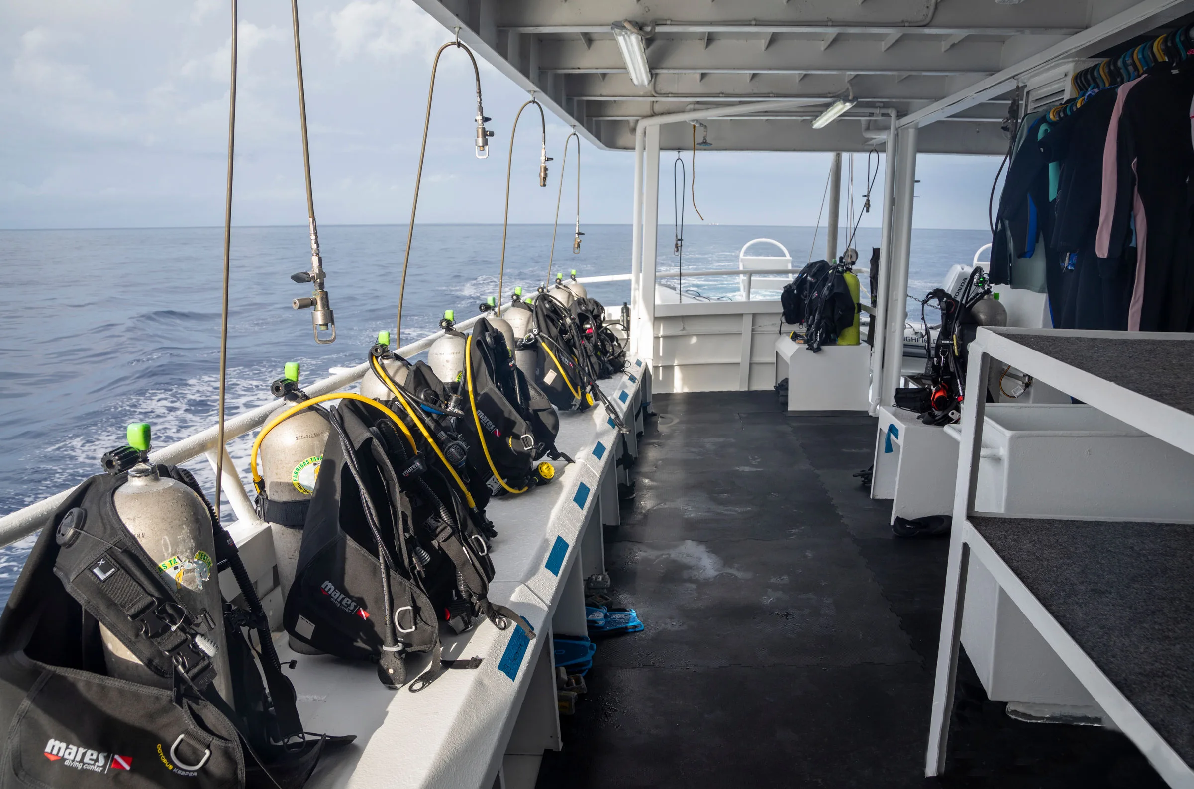 Dive deck with assembled gear and wetsuit racks