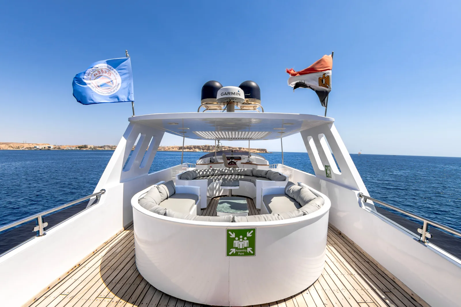 Bella 3 upper deck — operator's flag and the round settee