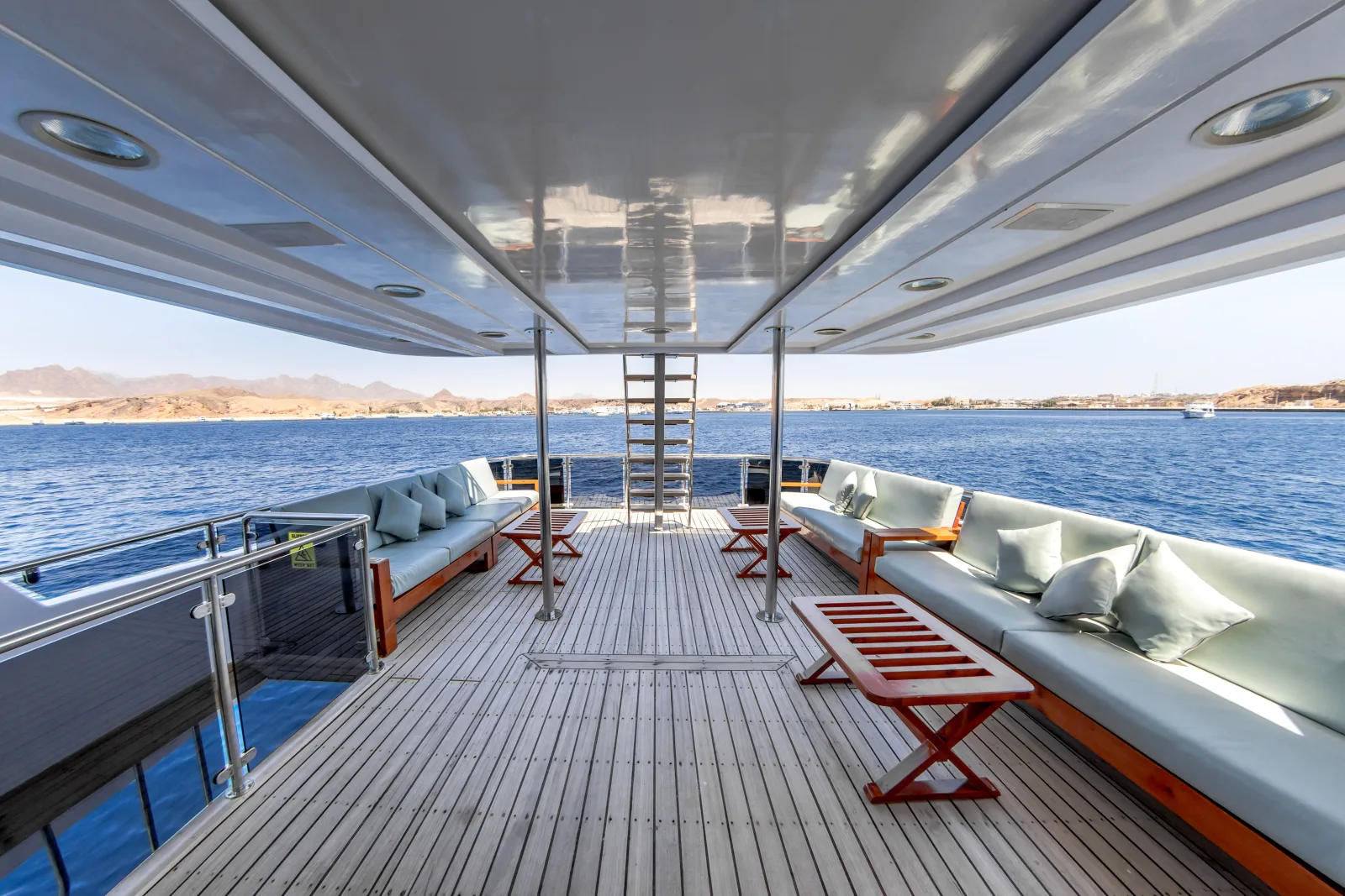 Bella 3 open deck with sofas and wooden tables