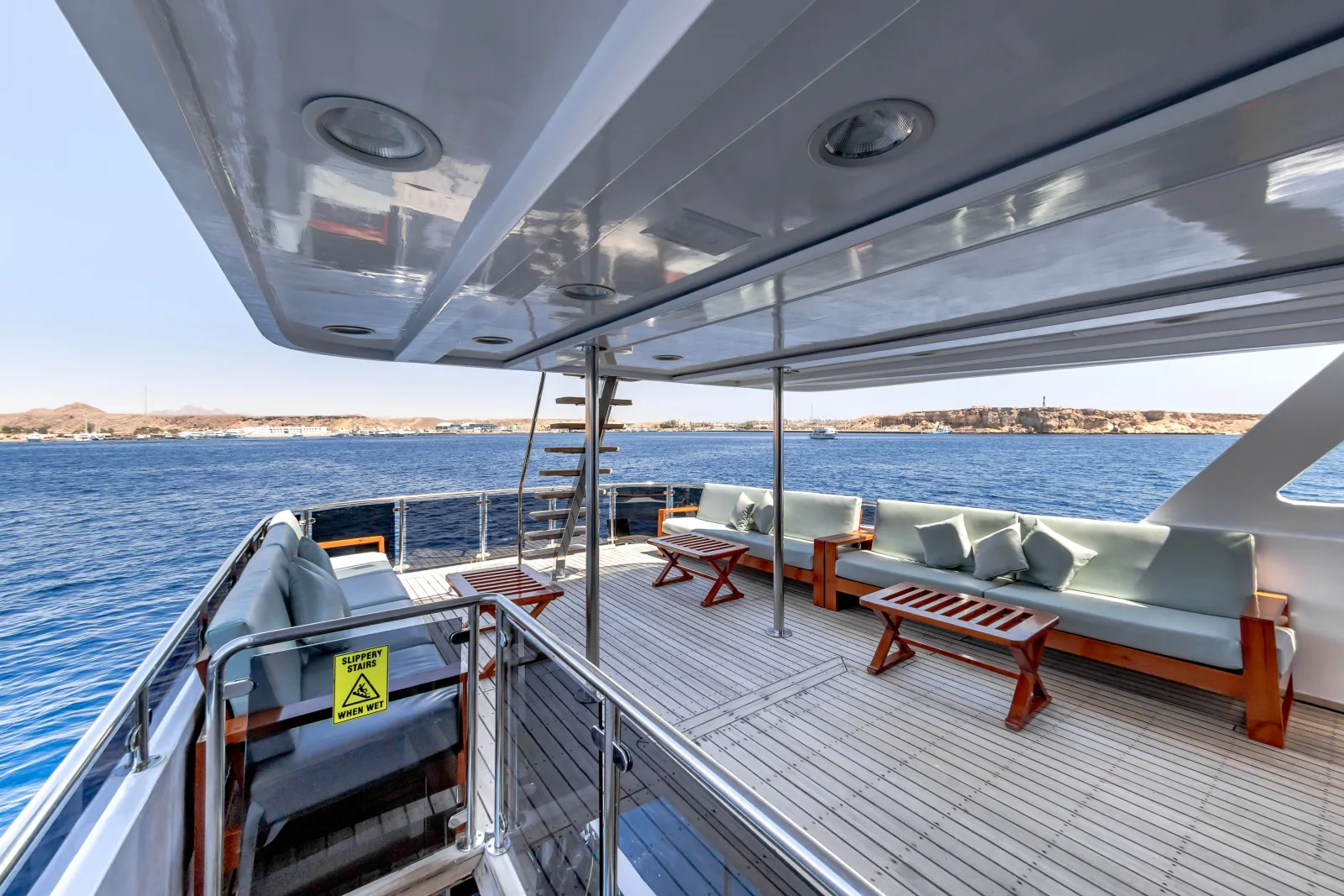 Bella 3 teak deck and padded benches along the rail