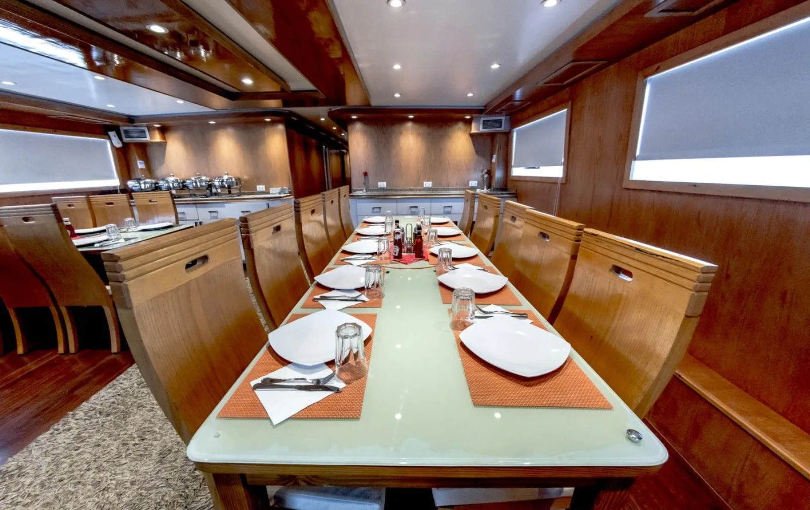 A laid dining table on board Bella 3