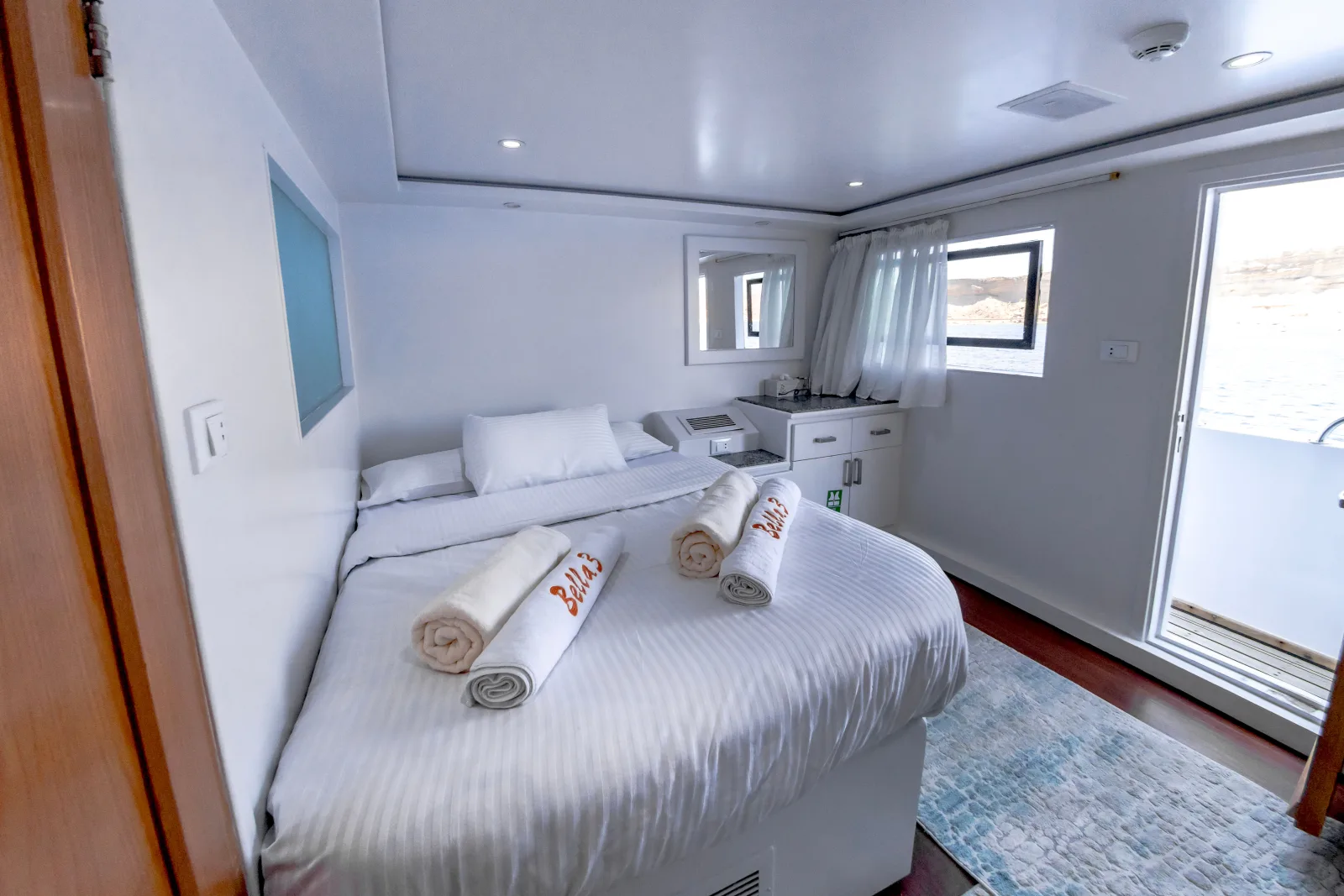 Bella 3 double cabin — bed by the window and the door to the deck