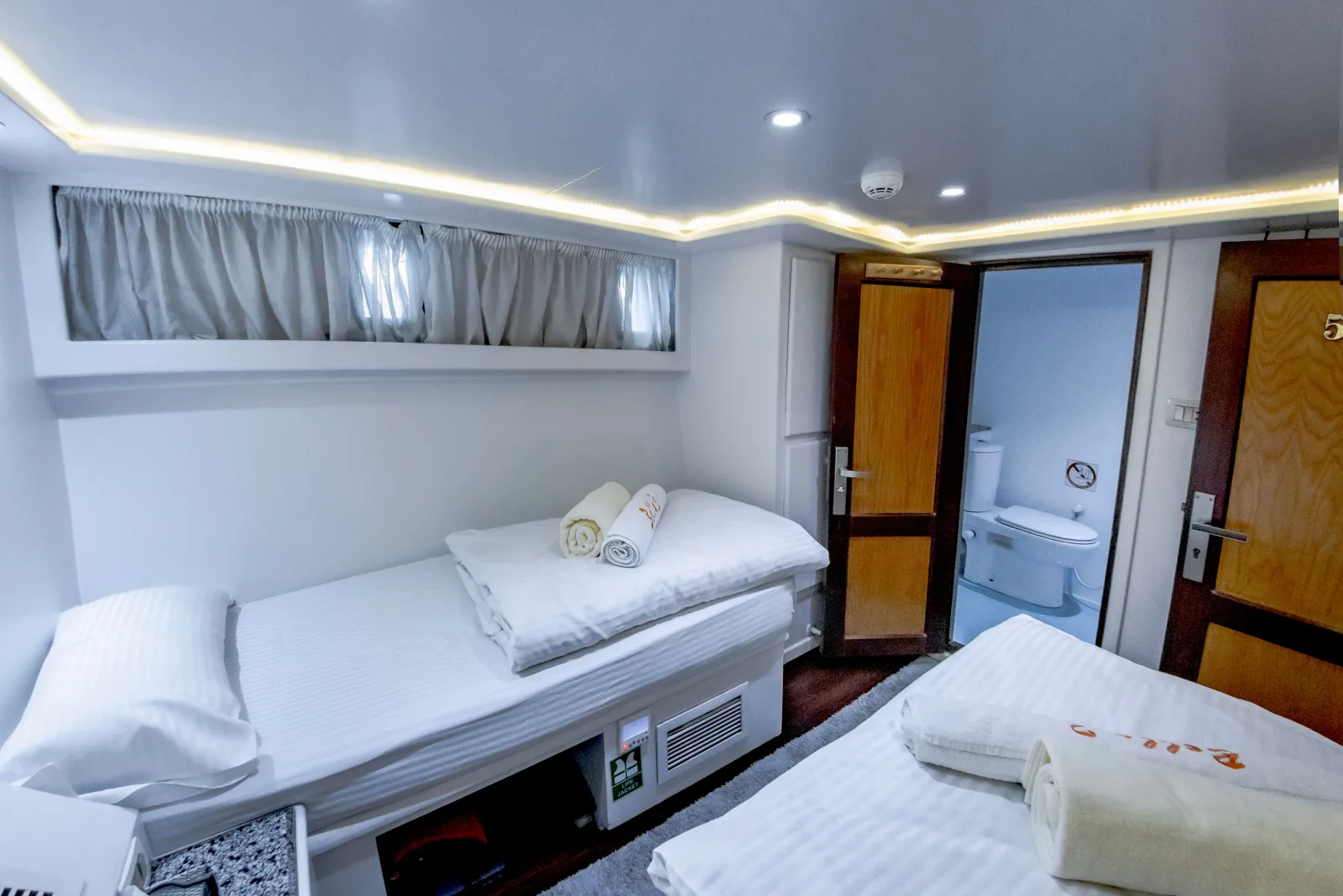 Bella 3 twin cabin with the door to its private bathroom open