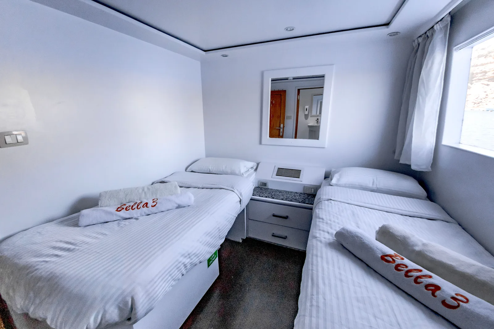 Bella 3 dive-deck twin cabin — two beds and a sea-view window
