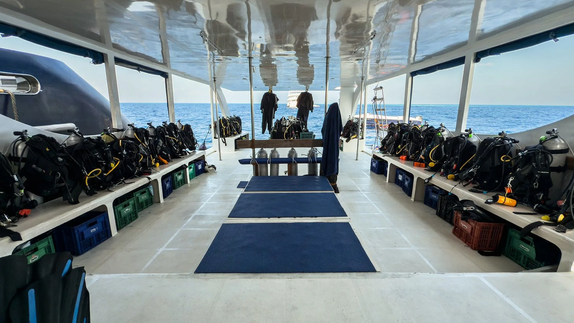 Dive deck on the Black Manta dhoni — gear stowed and ready