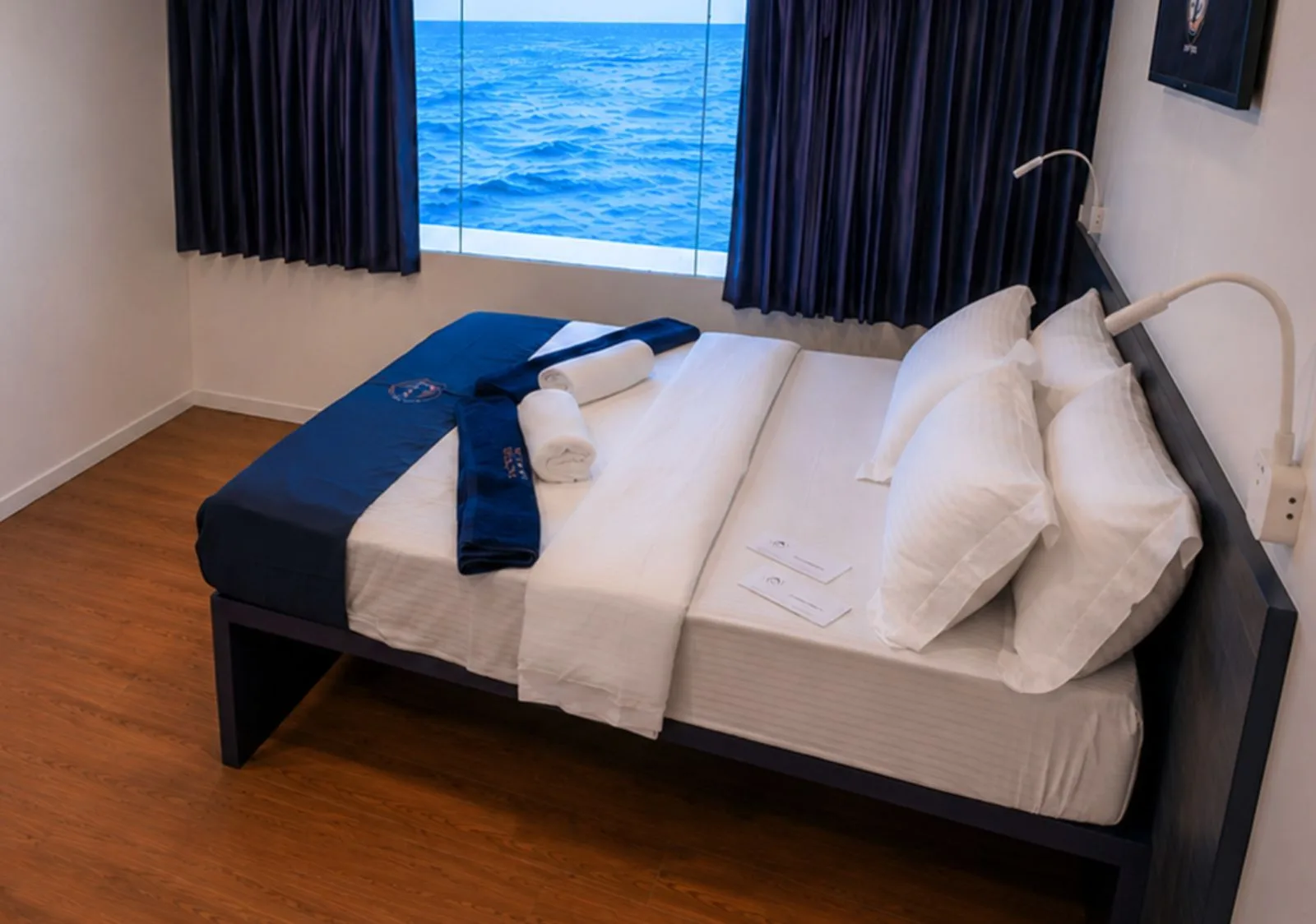 Premium cabin on the main deck of Black Manta — double bed by a panoramic window