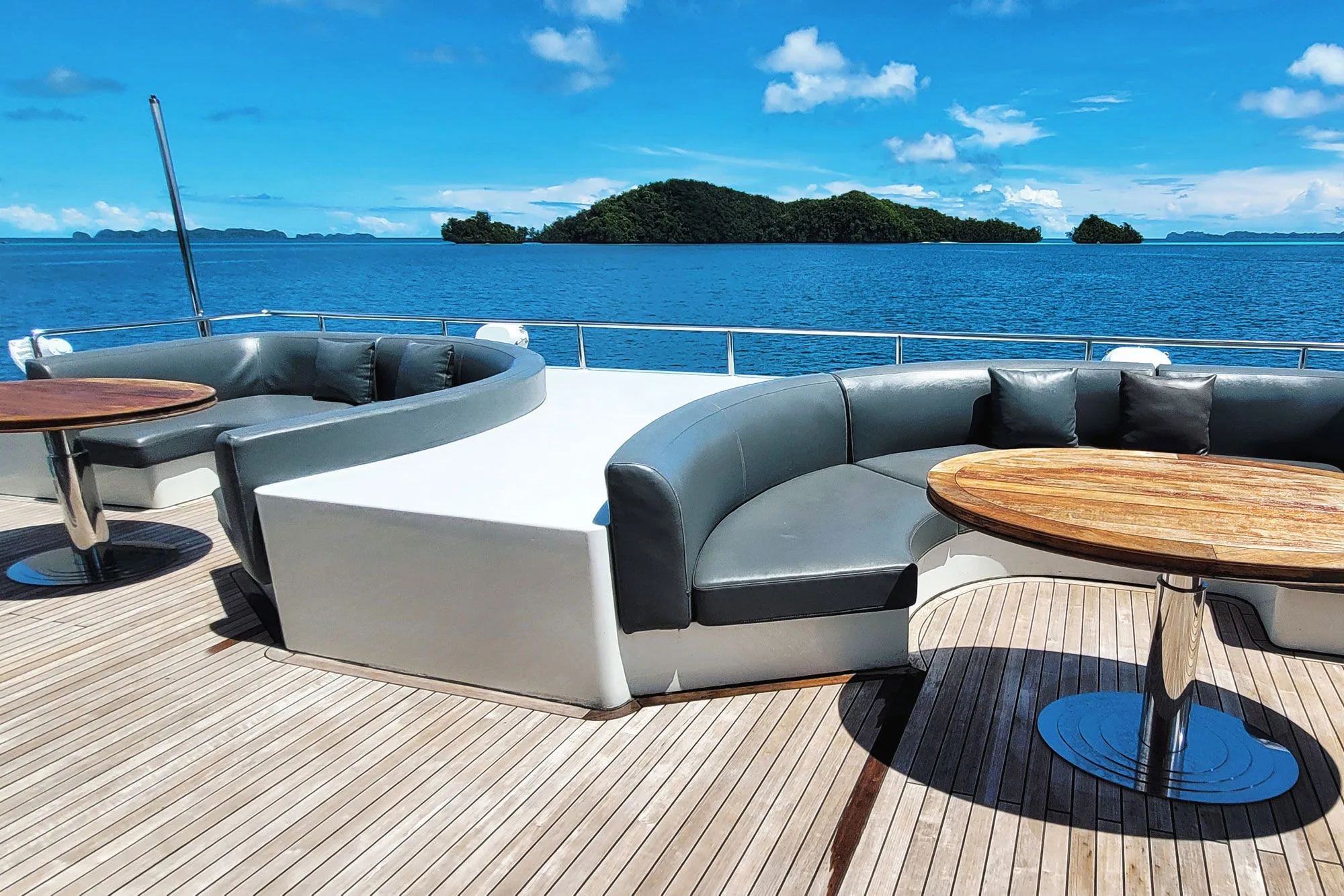 Curved outdoor sofa on the open deck of Black Pearl