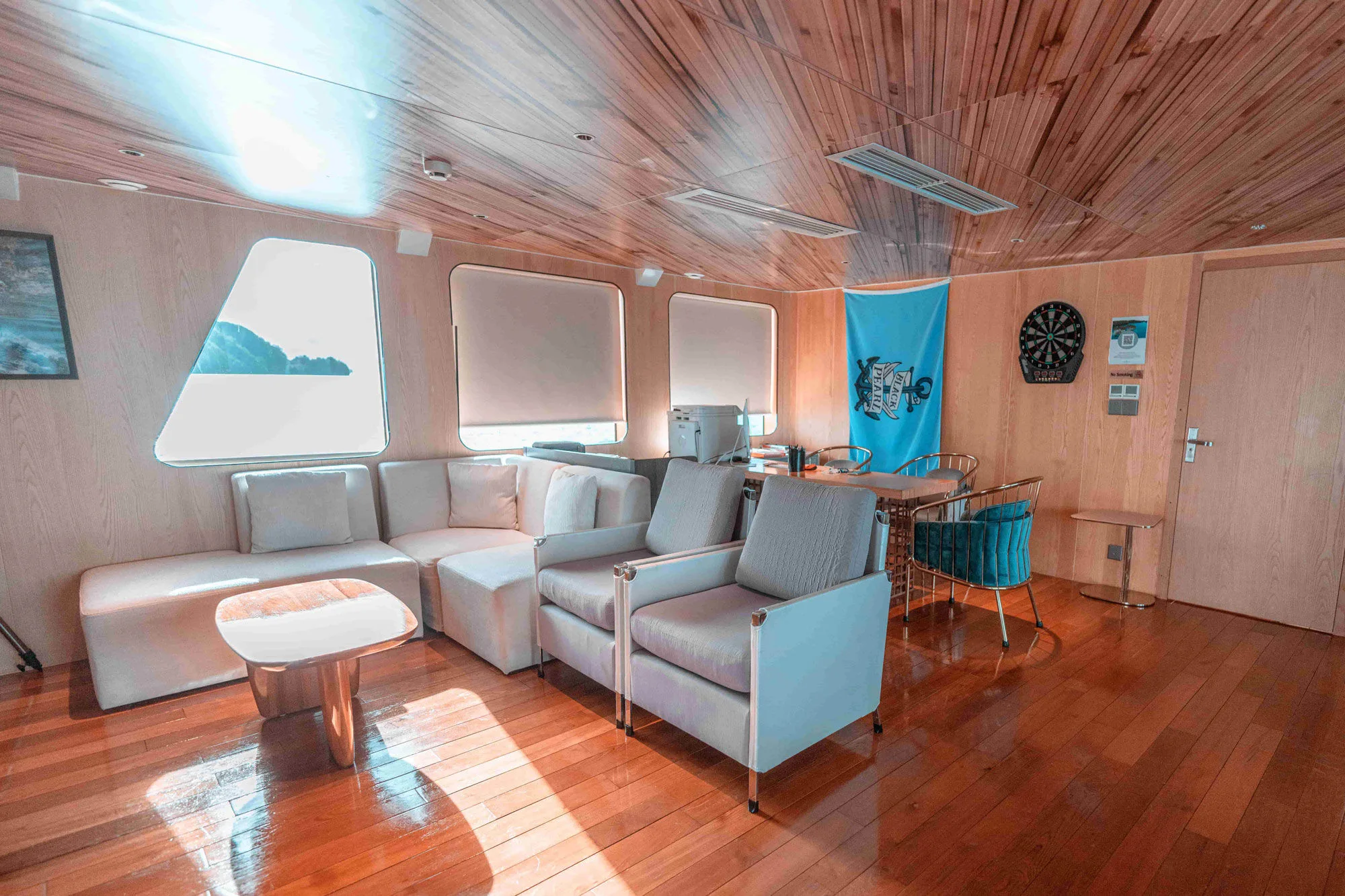 Indoor lounge of Black Pearl with a timber ceiling and soft sofas