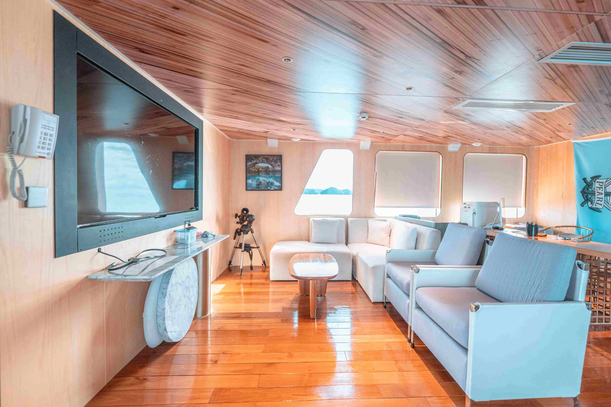 Black Pearl lounge with a large TV and seating area