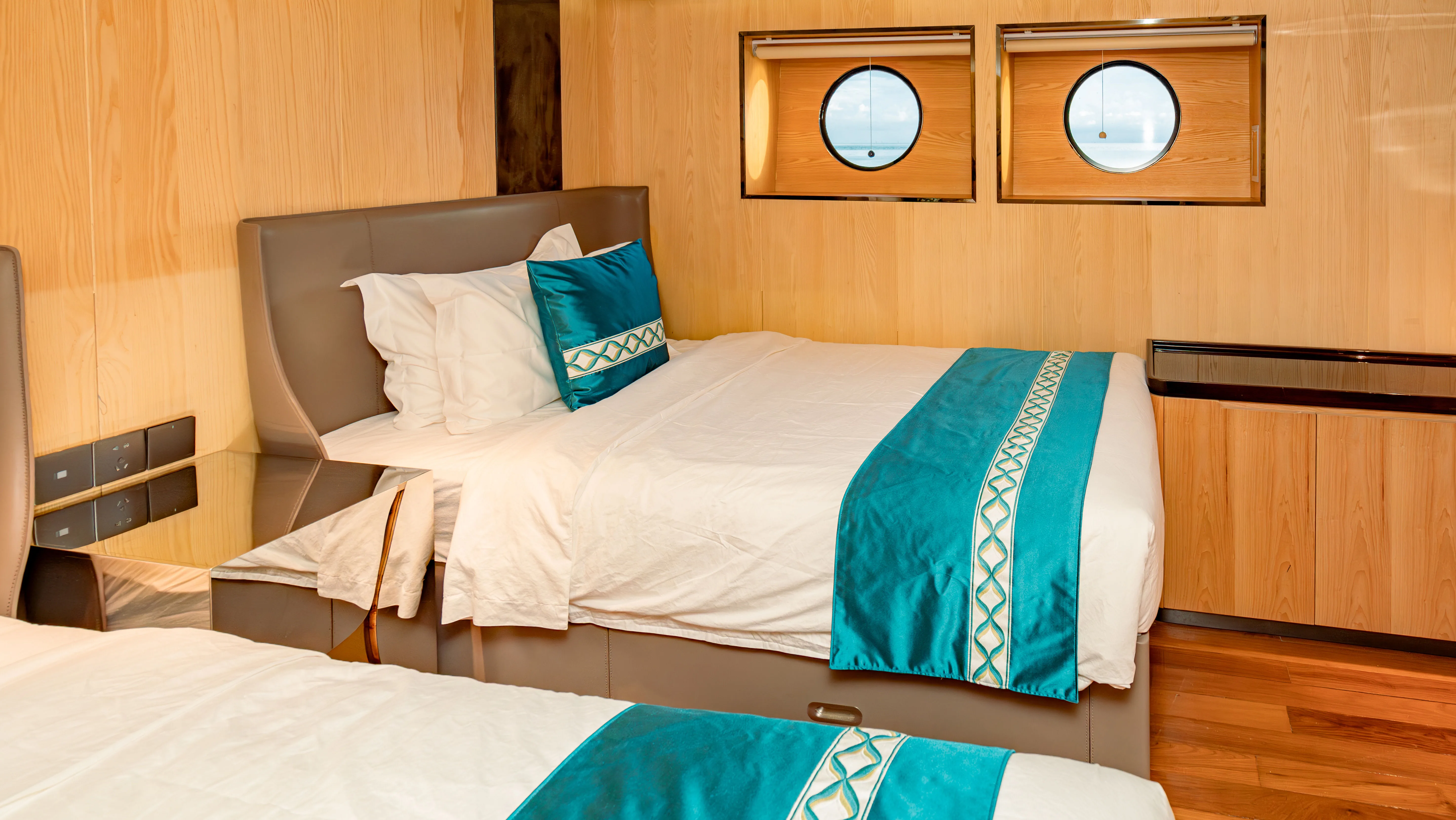 Deluxe Twin on Black Pearl — beds under the lower deck portholes