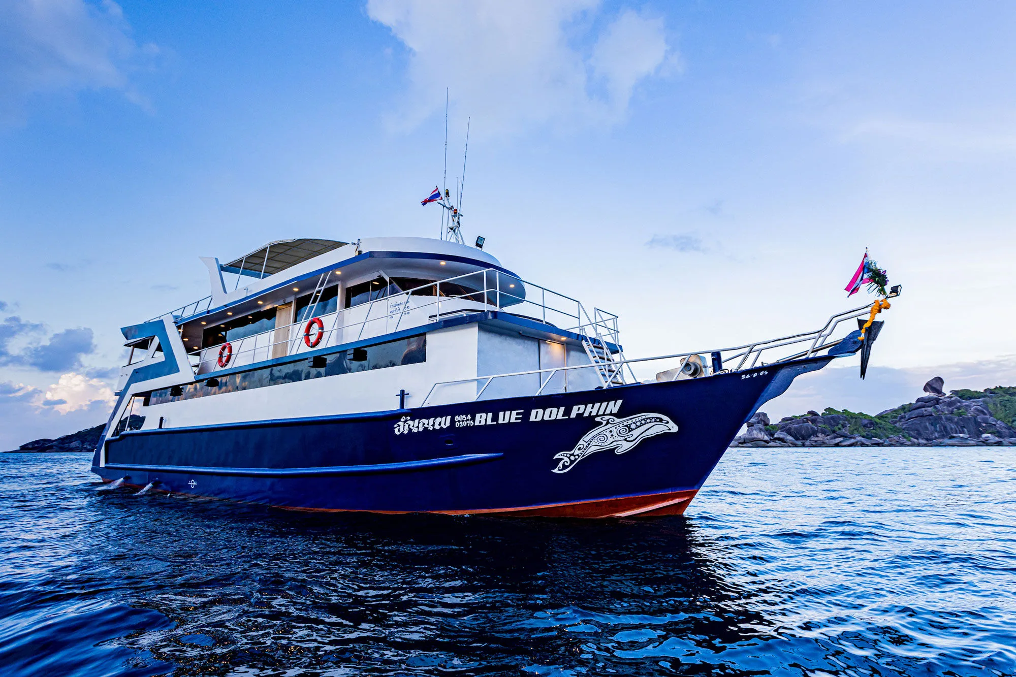 Blue Dolphin at anchor off the Similan Islands, name visible on the hull