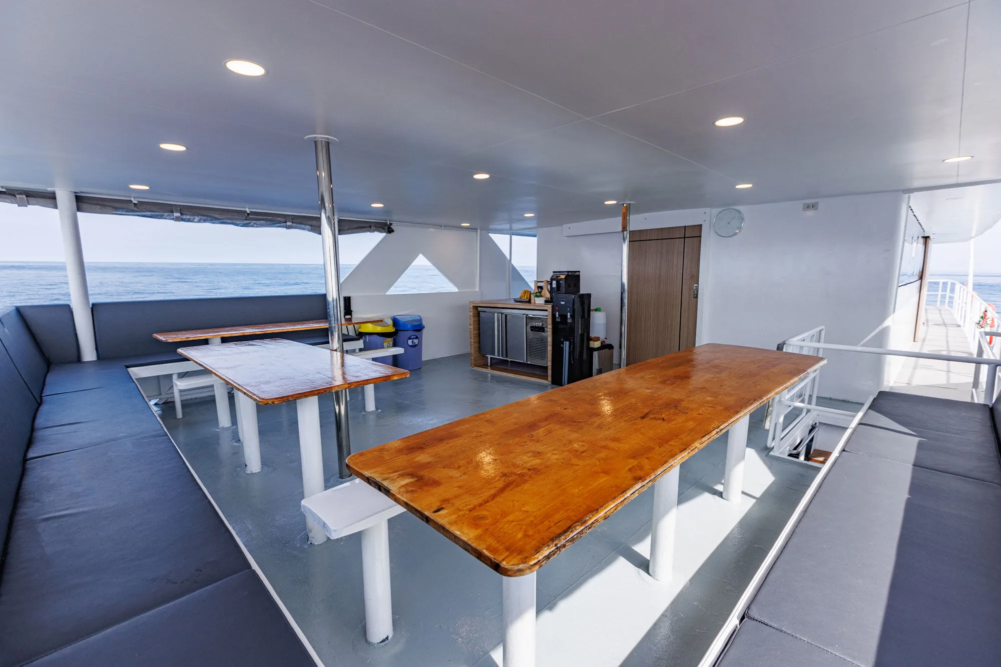 Tables and sofas in the dining area looking out at the sea