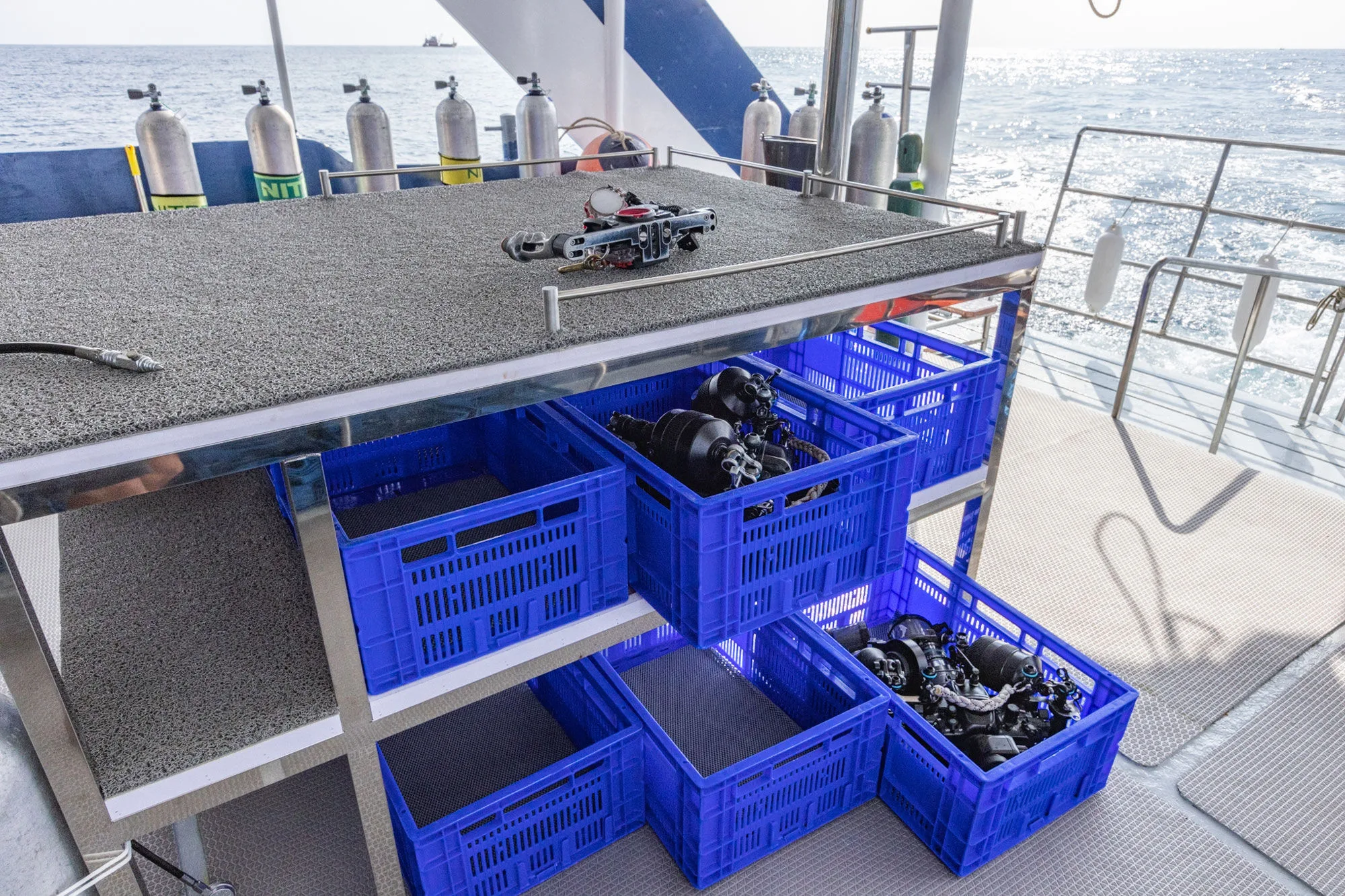 Gear crates stowed under the camera table on the dive deck