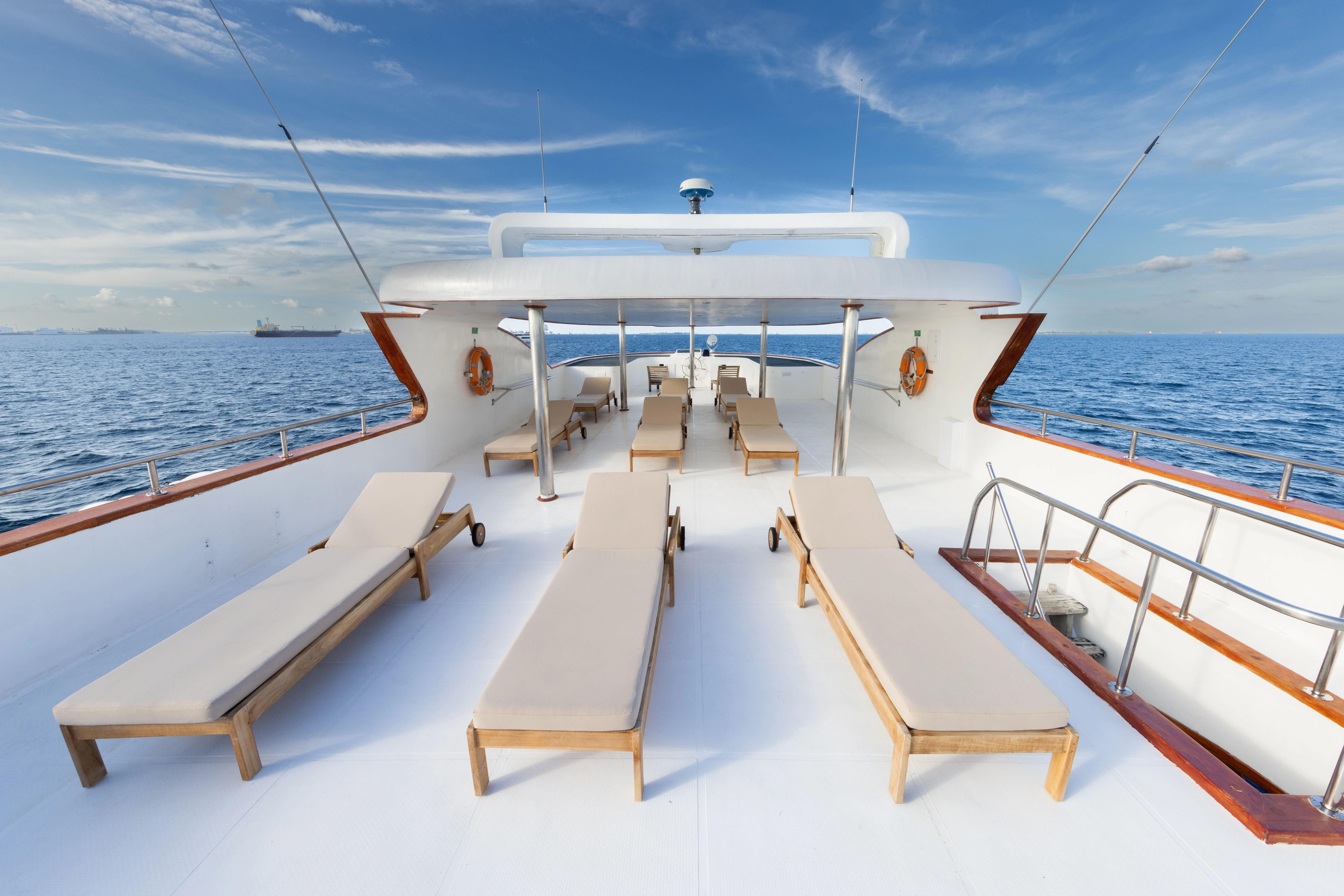 Sun deck of Blue Force Three with loungers under an awning