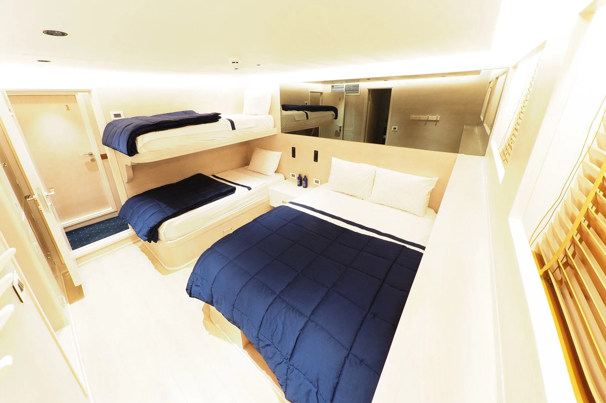 Triple cabin on the lower deck of Blue Force Three — bunk and double beds