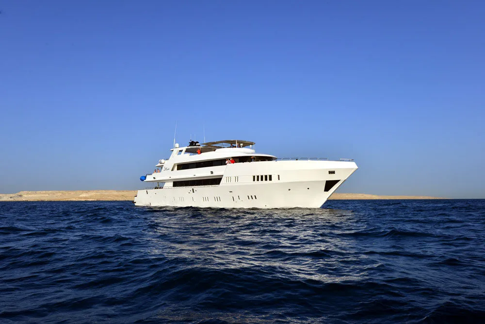 MY Blue against the desert shore of the Red Sea