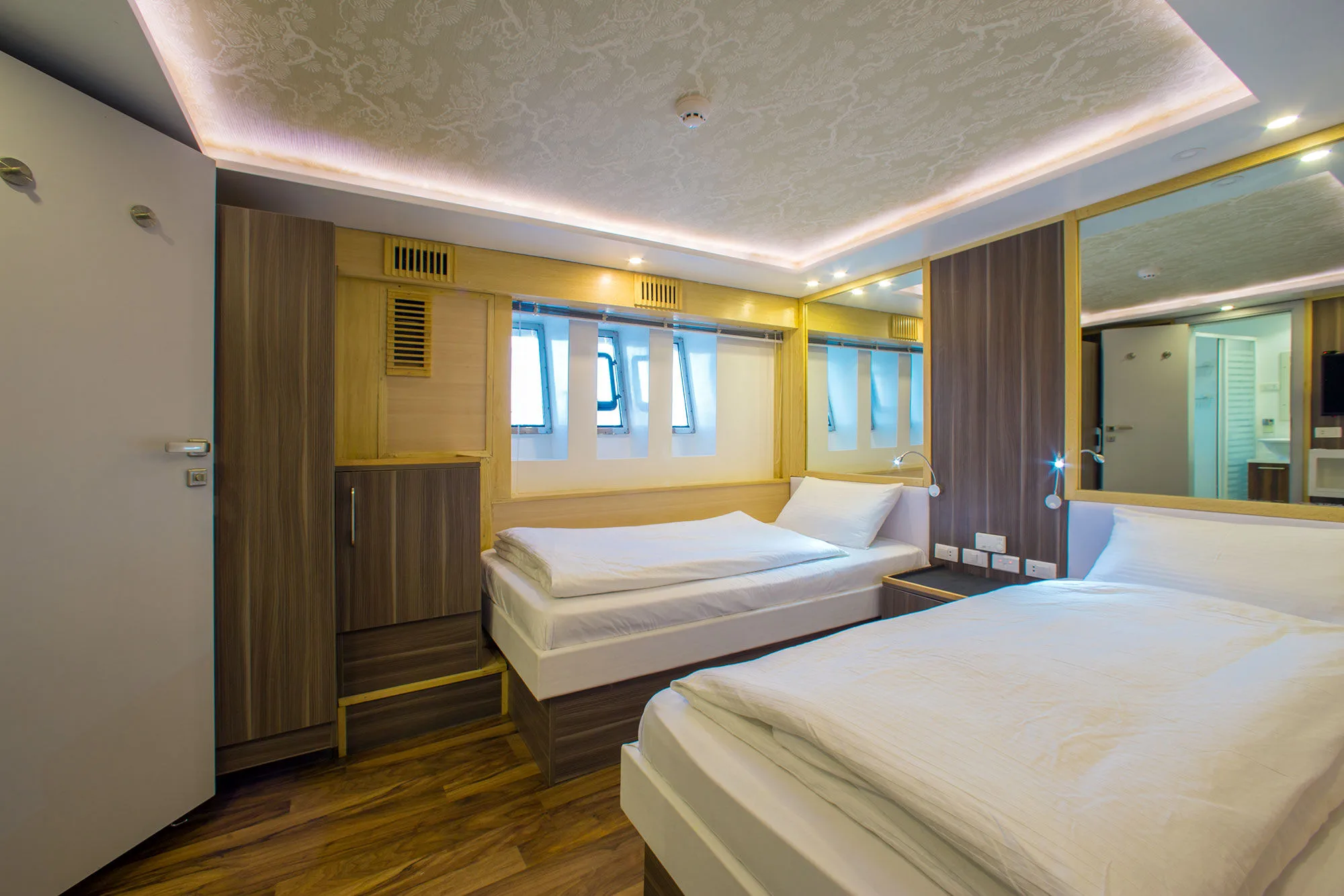 Twin cabin on the lower deck — two single beds and narrow windows