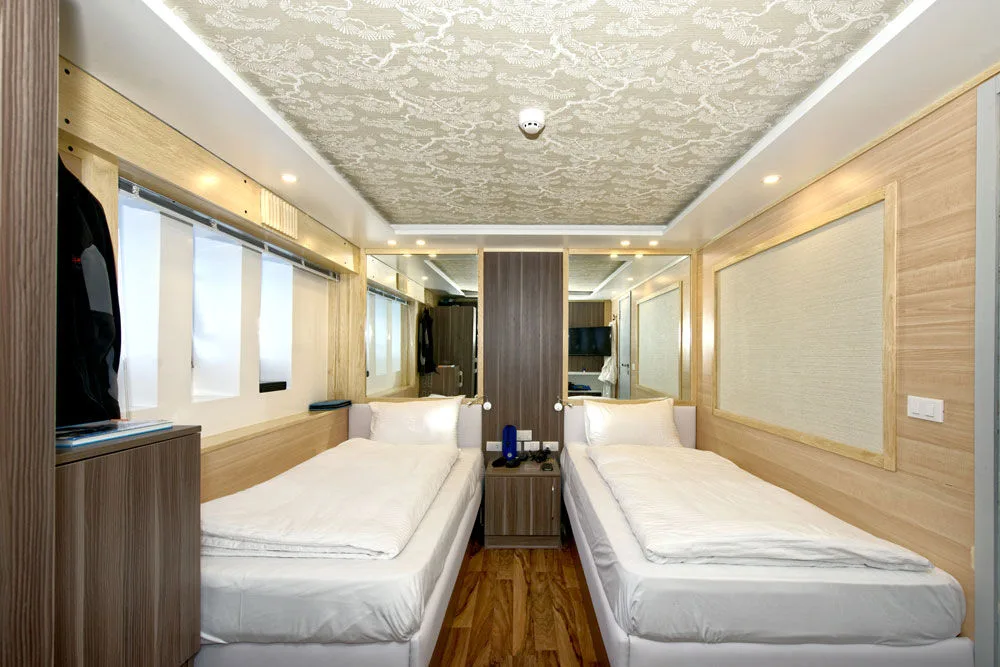 Twin Sea View — mirror between the beds and the bathroom door
