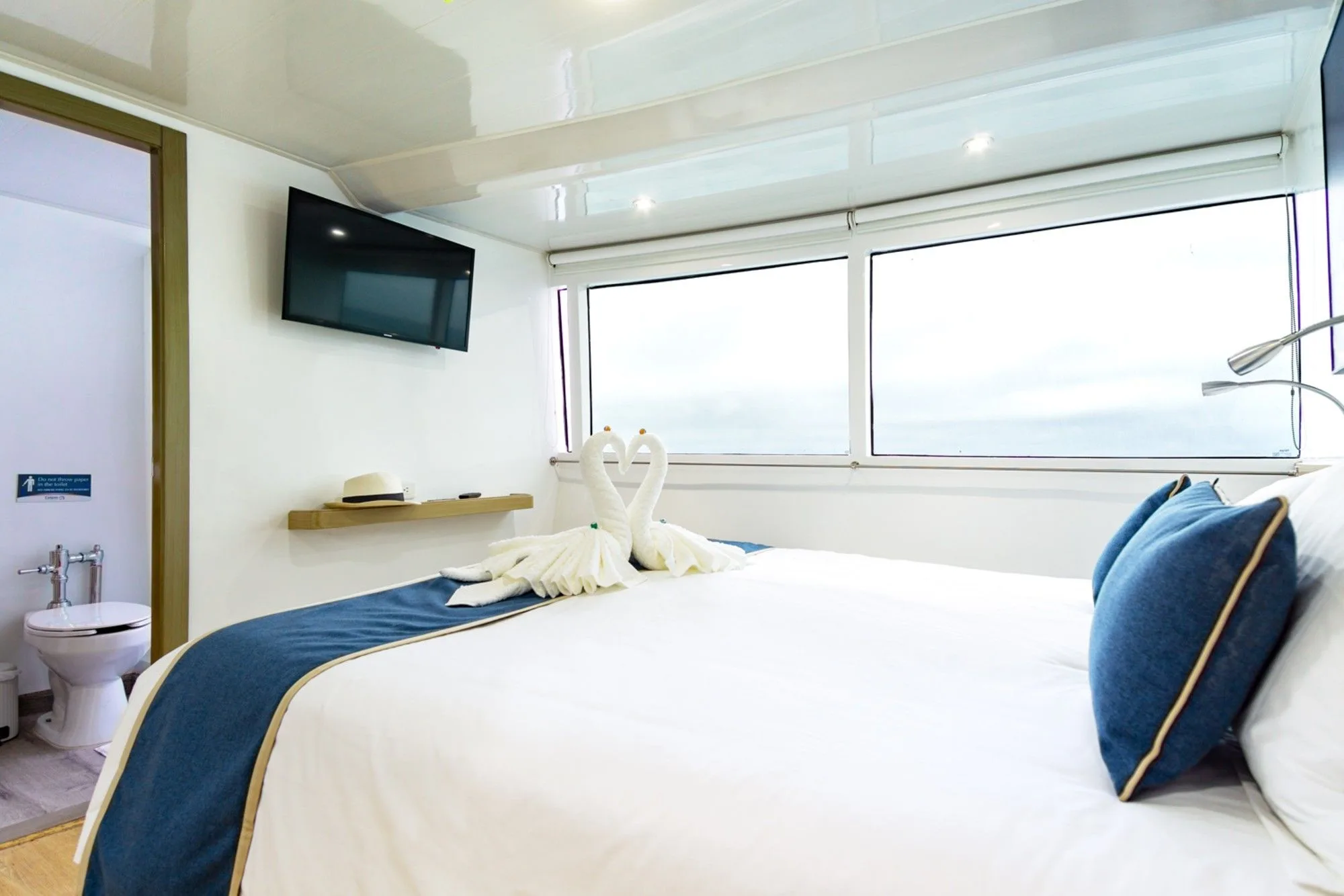 Calipso cabin — bed by the panoramic window and bathroom door