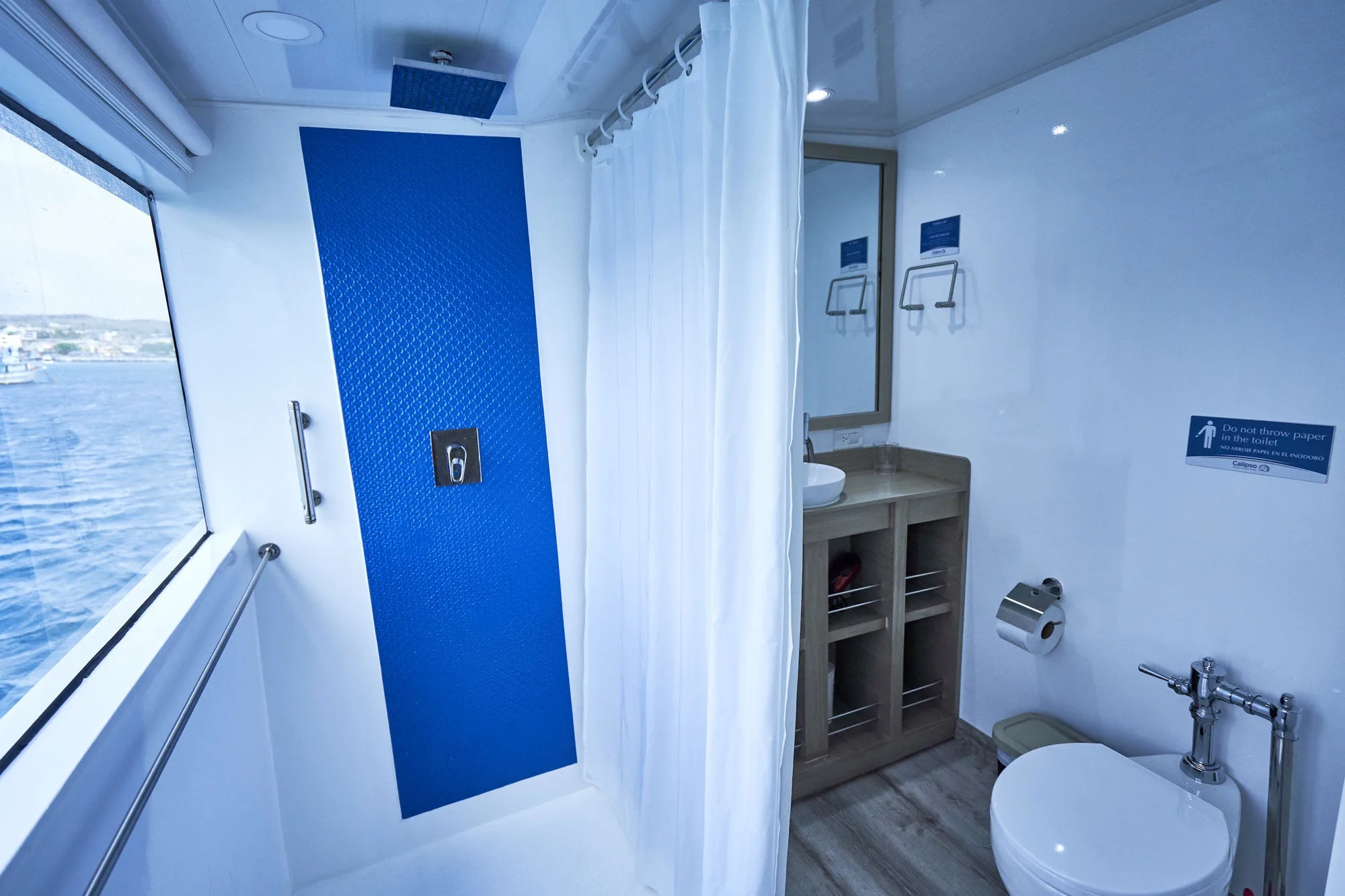 Calipso cabin bathroom — shower and a window onto the ocean