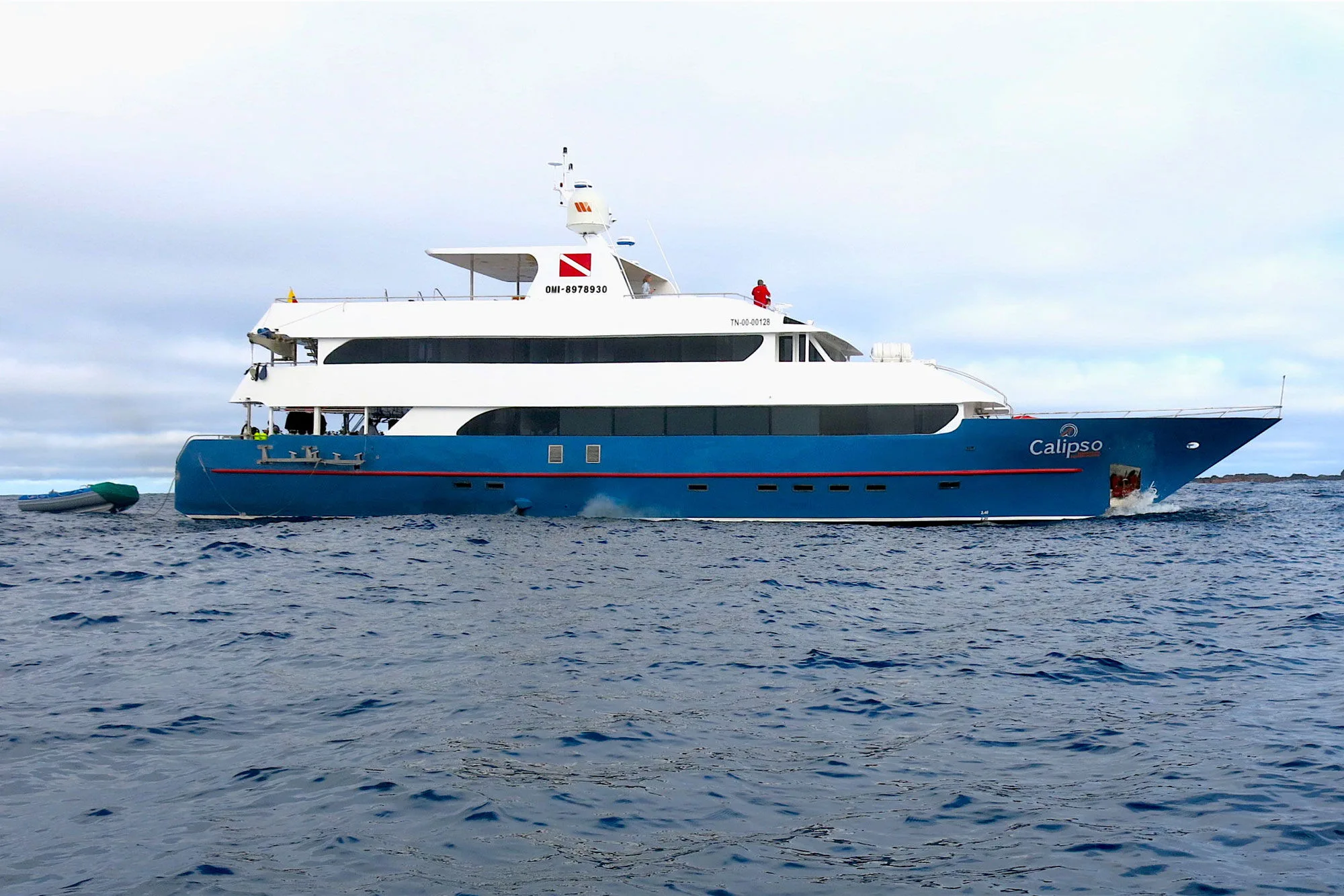 Calipso in profile — blue hull and white superstructure