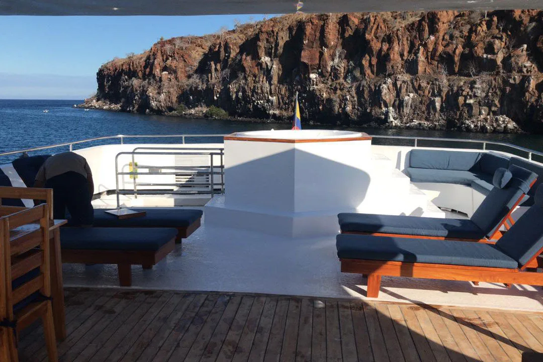 Upper deck lounge area on Calipso facing the cliffs