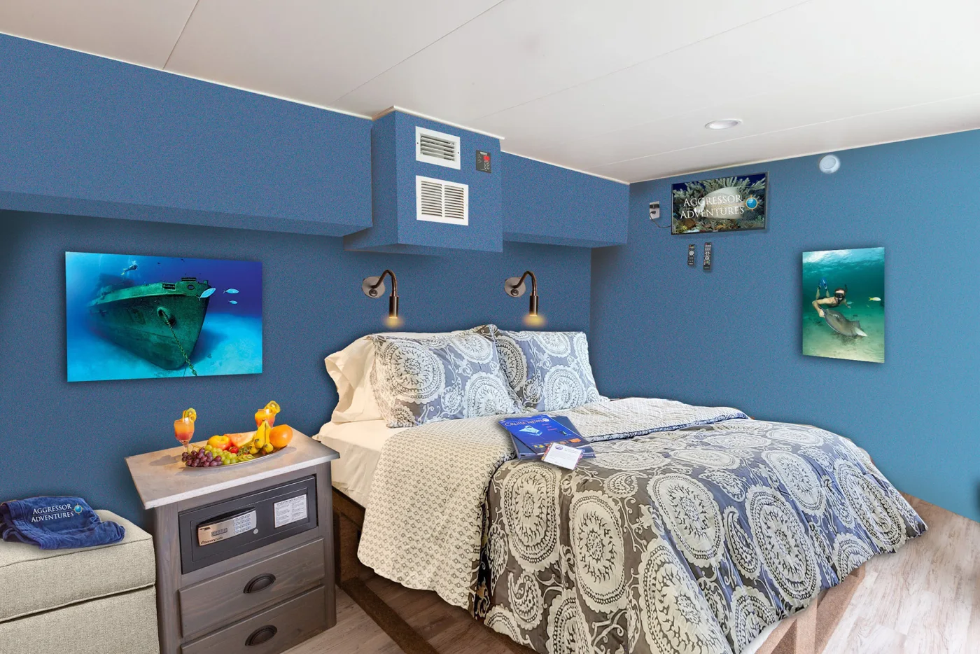 Master stateroom on Cayman Aggressor IV with a king bed against a blue bulkhead