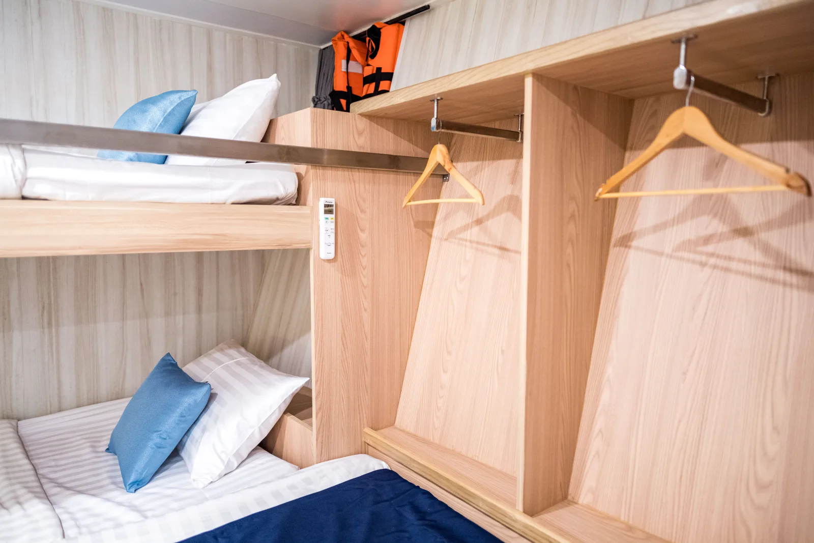 Open wardrobe and shelves in the Andaman Triple cabin