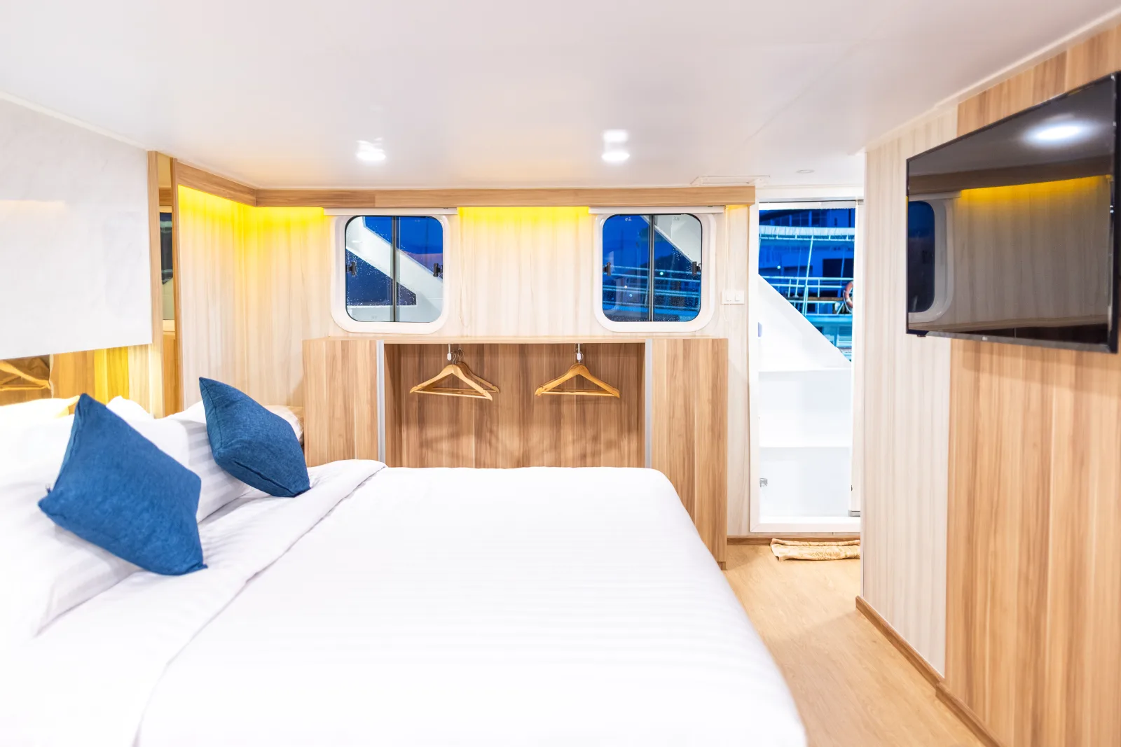 Master cabin on Deep Andaman Queen with a king-size bed and TV