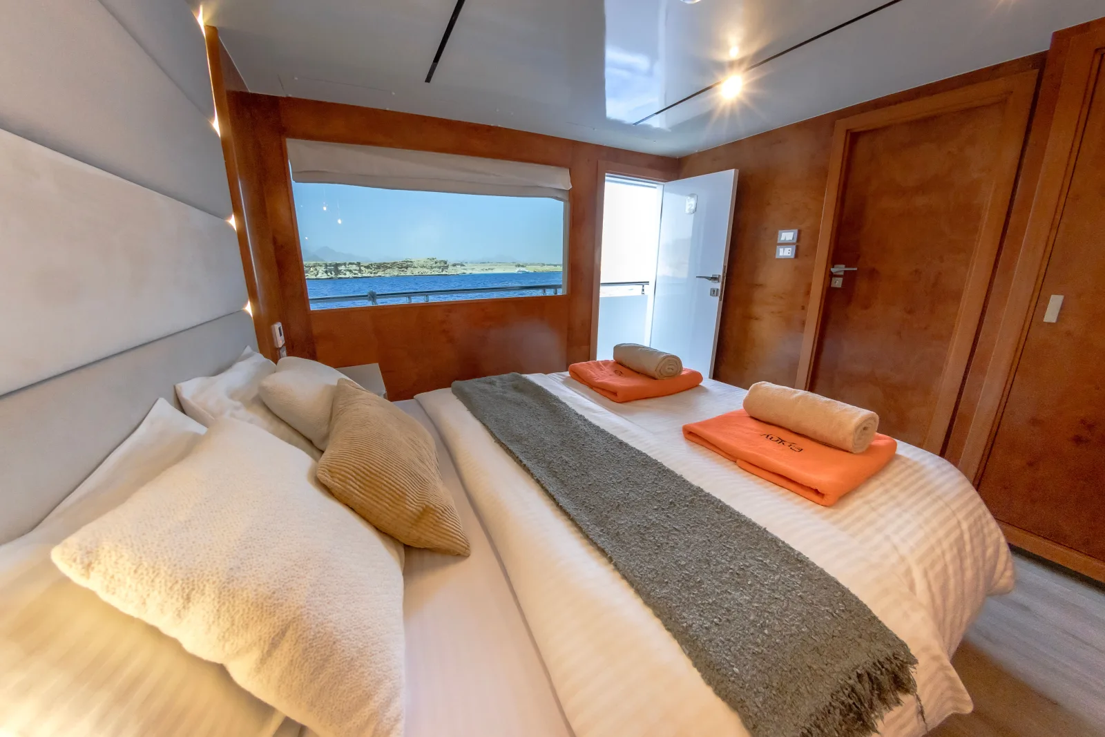 Upper deck cabin on Eriny — double bed facing the sea-view window