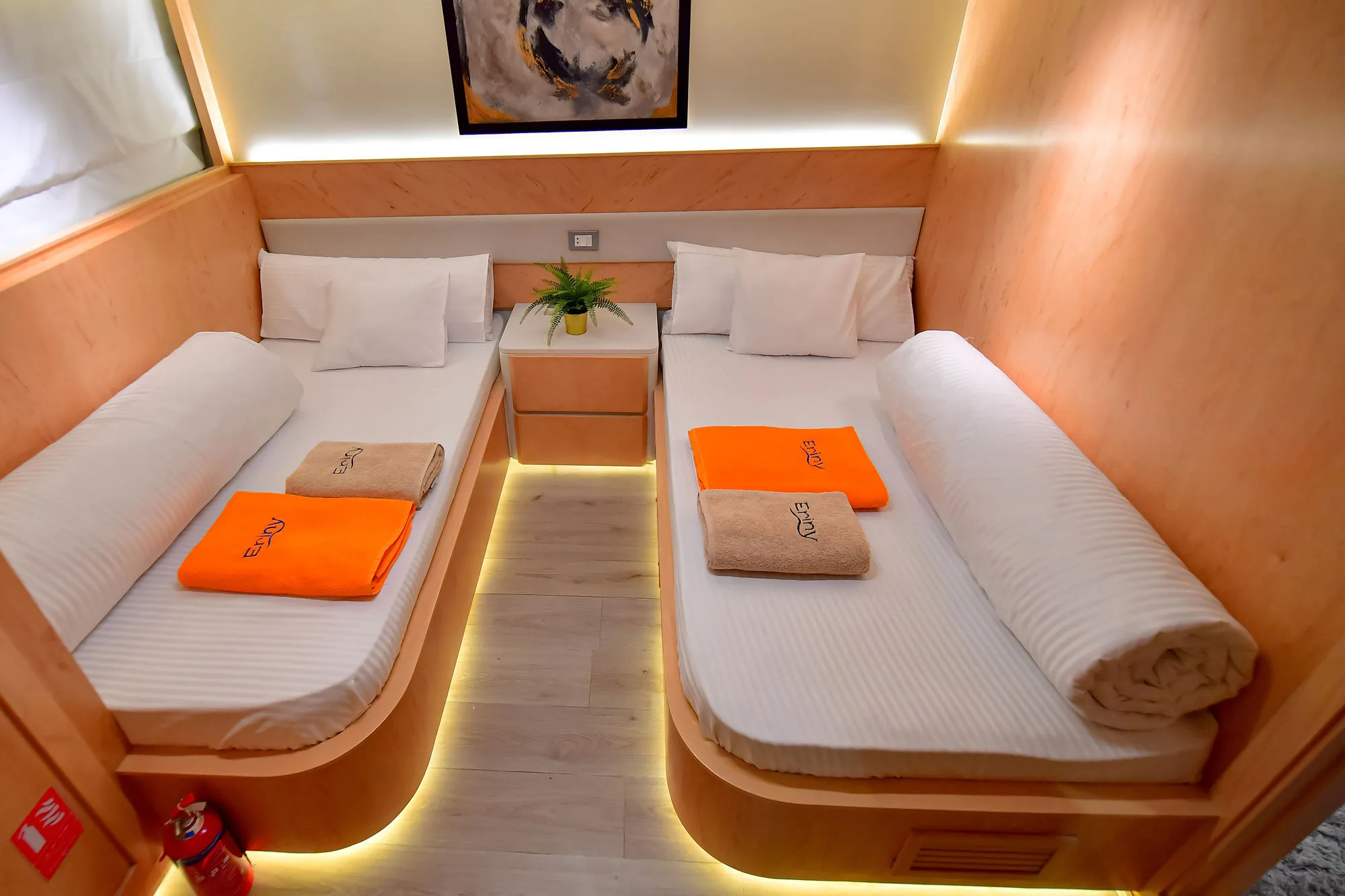 Lower deck cabin on Eriny — pale joinery and floor-level lighting