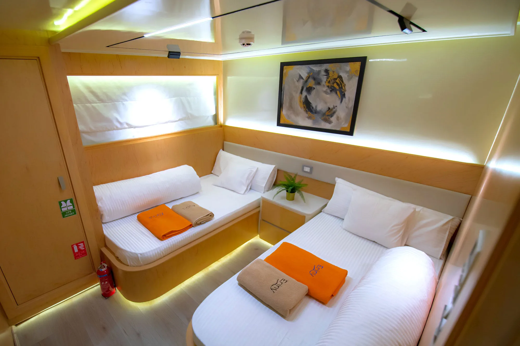 Separate beds and a bedside unit in a lower deck cabin on Eriny