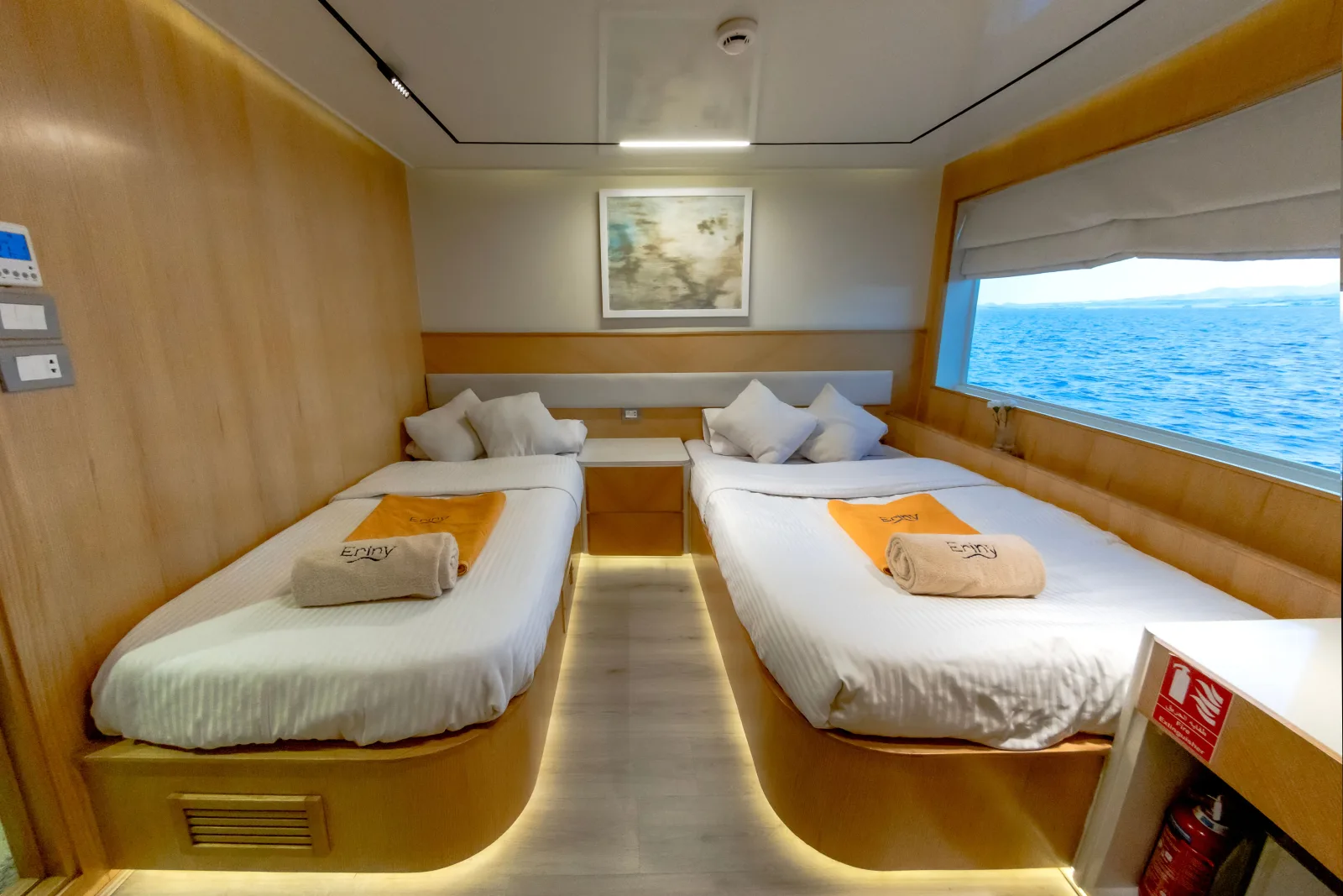 Separate beds and perimeter lighting in a twin cabin on Eriny
