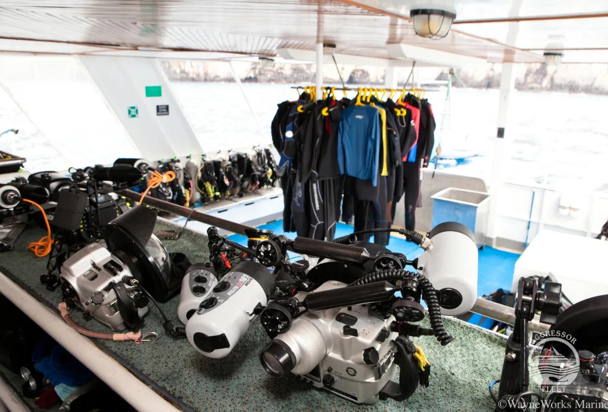 Camera table with underwater housings and drying wetsuits