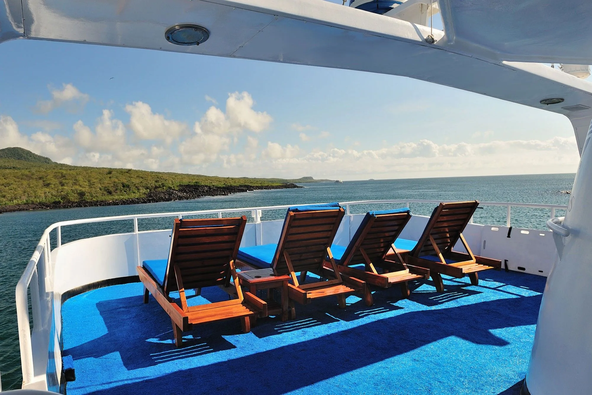 Solarium of Galapagos Aggressor III with wooden sun beds