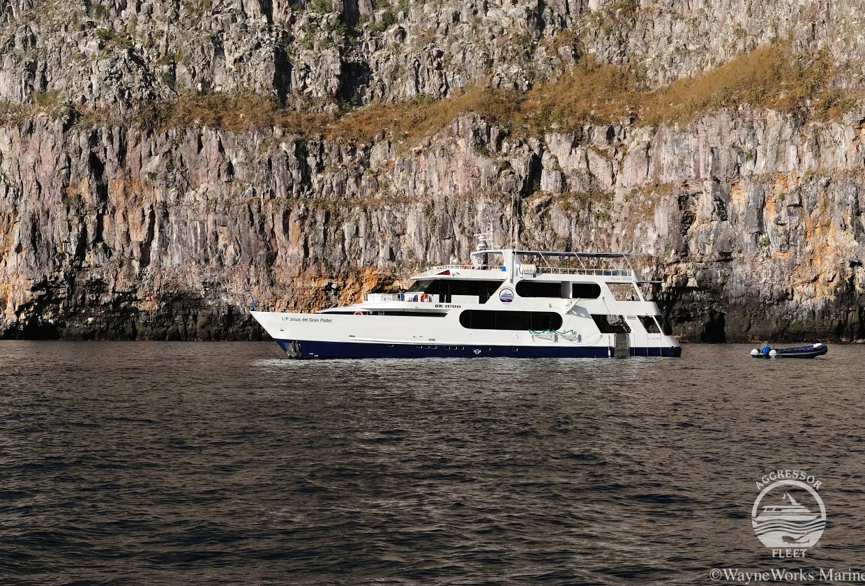 Galapagos Aggressor III anchored below a sheer cliff