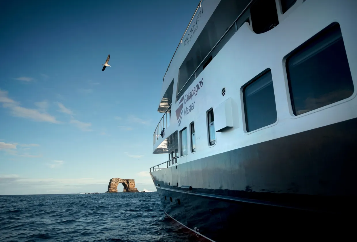Side of Galapagos Master with Darwin's rock in the distance