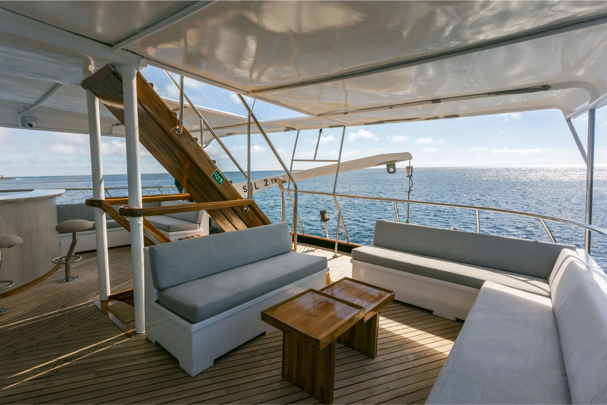 Sofas and a table on the open deck of Galapagos Sky
