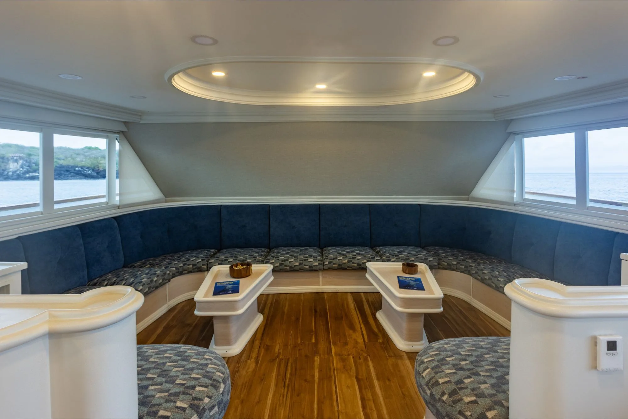 Soft seating in the salon of Galapagos Sky with panoramic windows