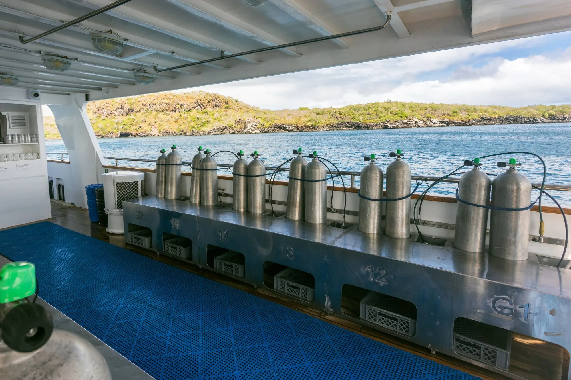 Dive deck of Galapagos Sky with tanks and an island view