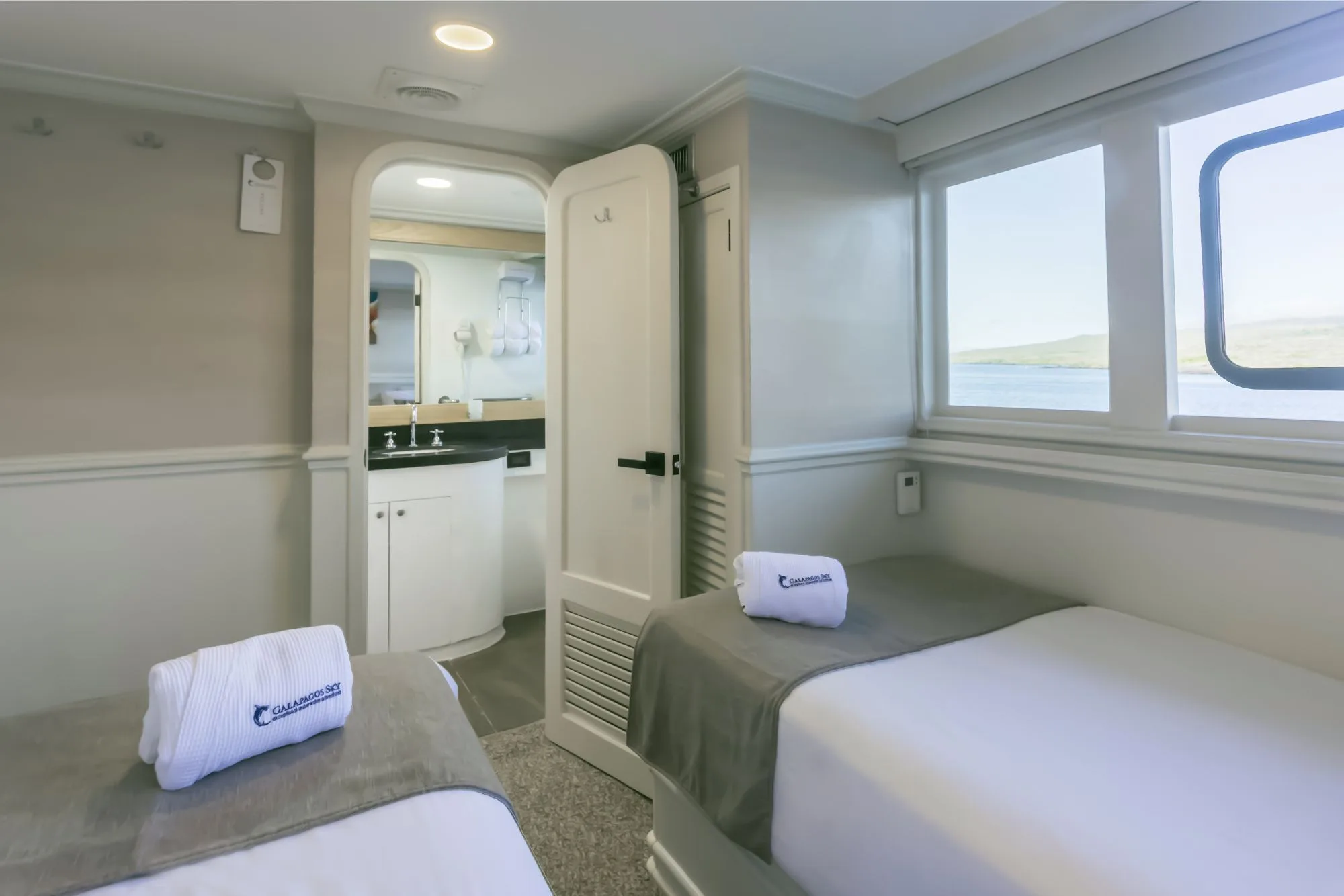 Deluxe Stateroom on Galapagos Sky — portholes above the bed
