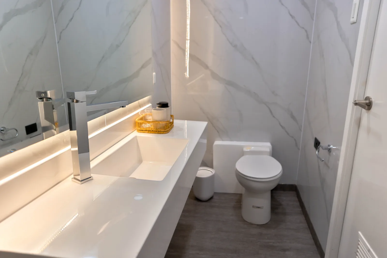 Cabin bathroom on Galaxy Diver II — basin and backlit mirror