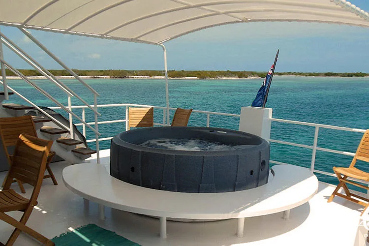 Jacuzzi on the shaded deck overlooking a turquoise shallow